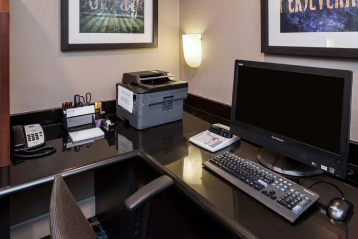 image 24-hour business center with a desk, computer, and printer — handy for remote work during an extended stay