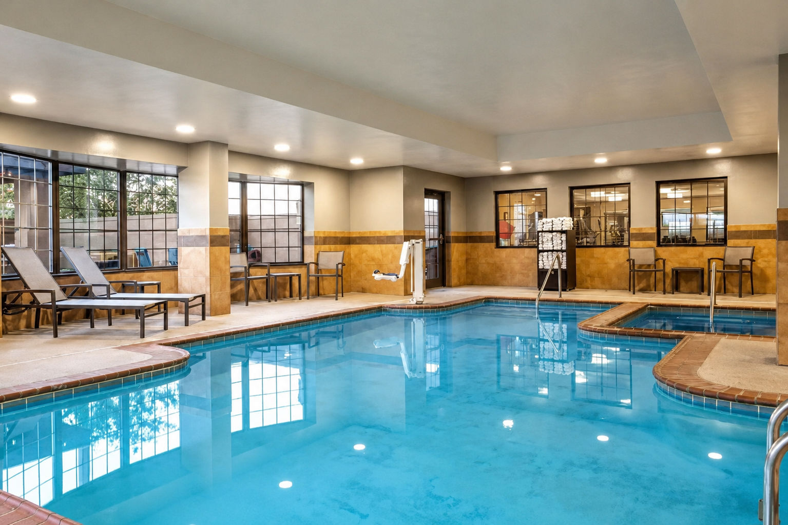 image Refresh with a swim in the indoor heated pool, surrounded by natural light and comfortable lounge chairs