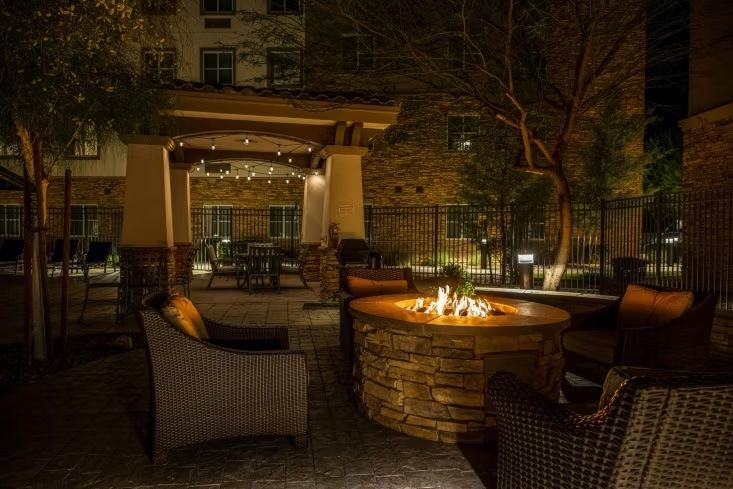 image Gather around the outdoor fire pit under string lights.