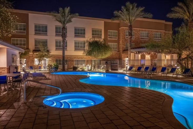 image Unwind in the heated outdoor pool and hot tub with cozy lights.