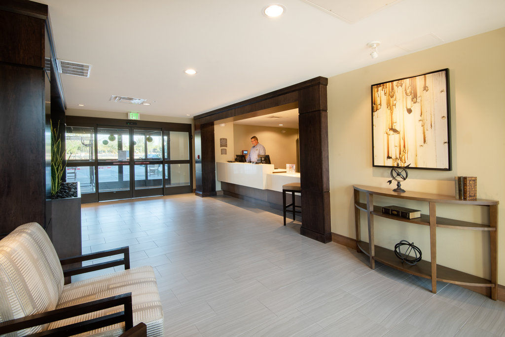 image Front desk reception with floor-to-ceiling glass entry doors and a welcoming seating area