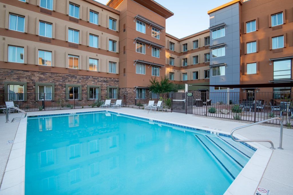image Outdoor pool with gray lounge chairs along the tiled deck