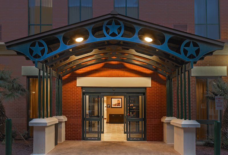 image Ground-level exterior entrance with glass doors and exterior signage