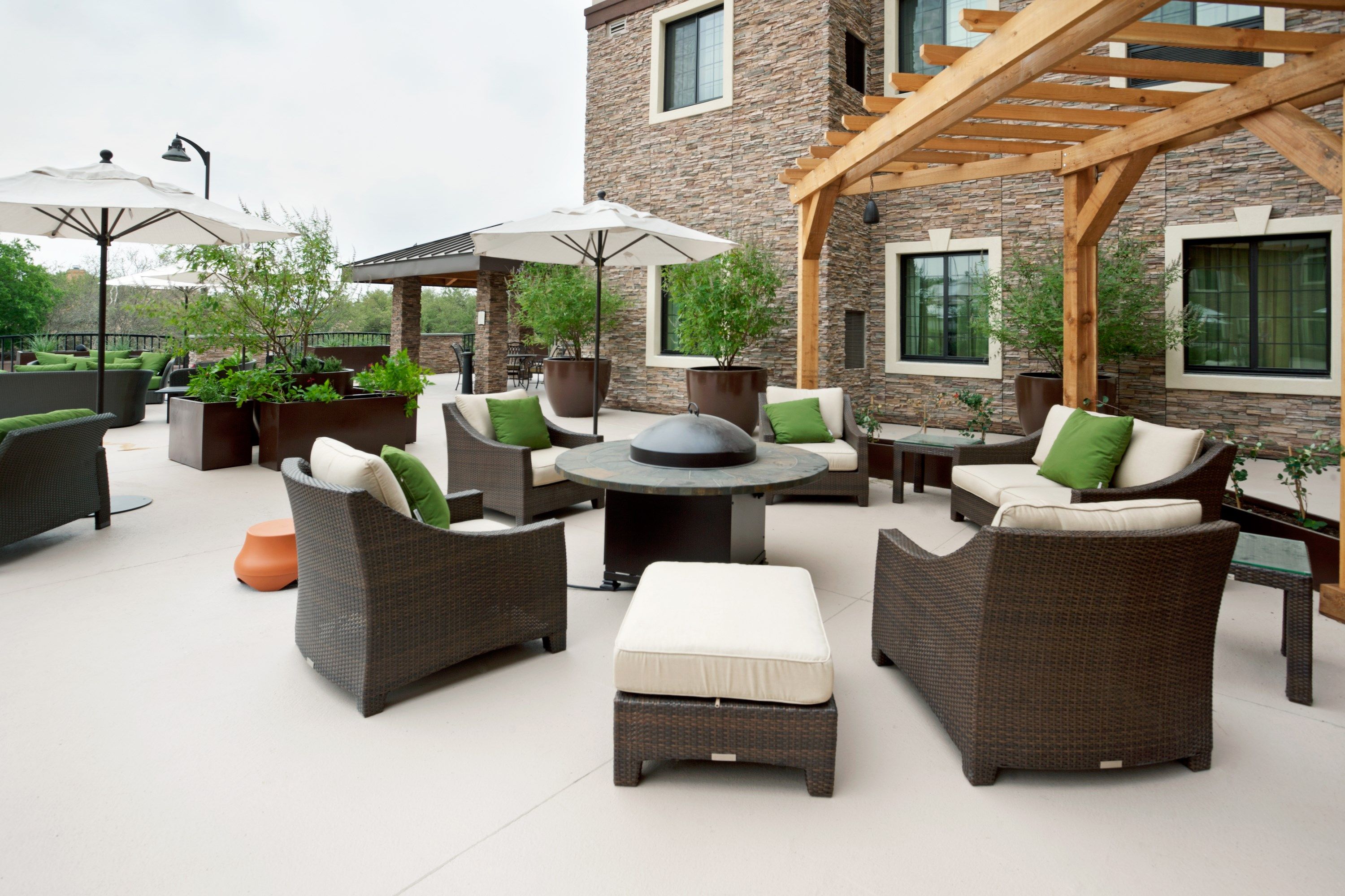 image Outdoor common area with seating and garden setting.