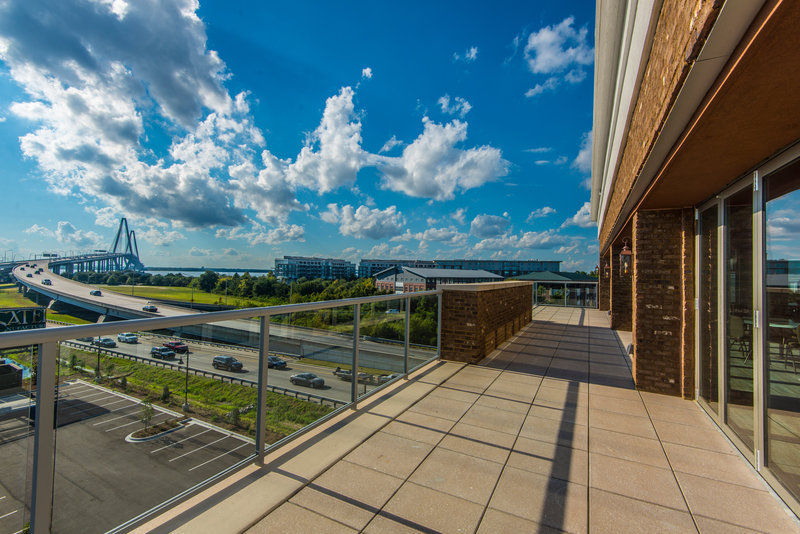 image Rooftop patio offering sweeping views of the Arthur Ravenel Bridge and Charleston Harbor.