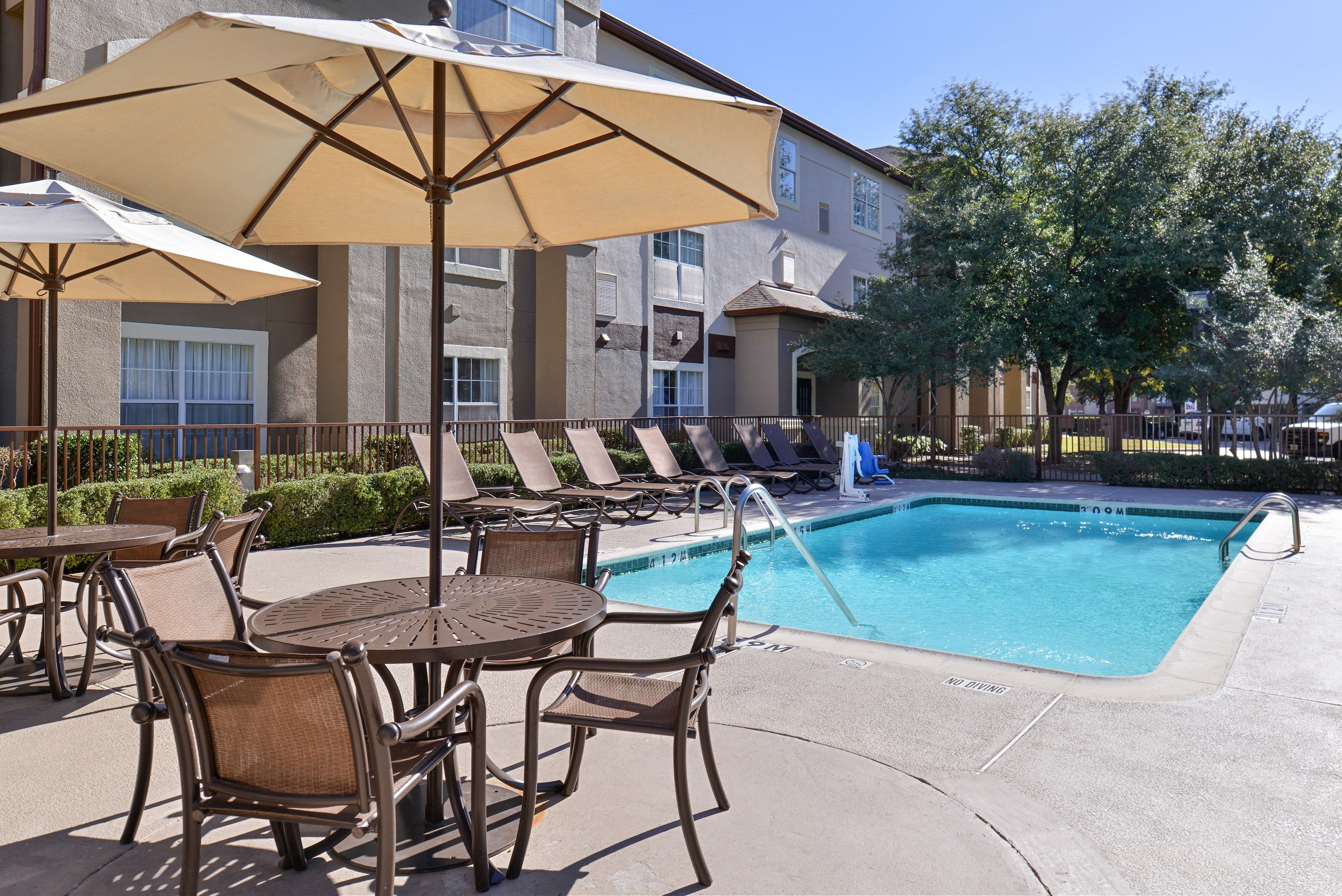 image Lounge around the on-site outdoor pool.