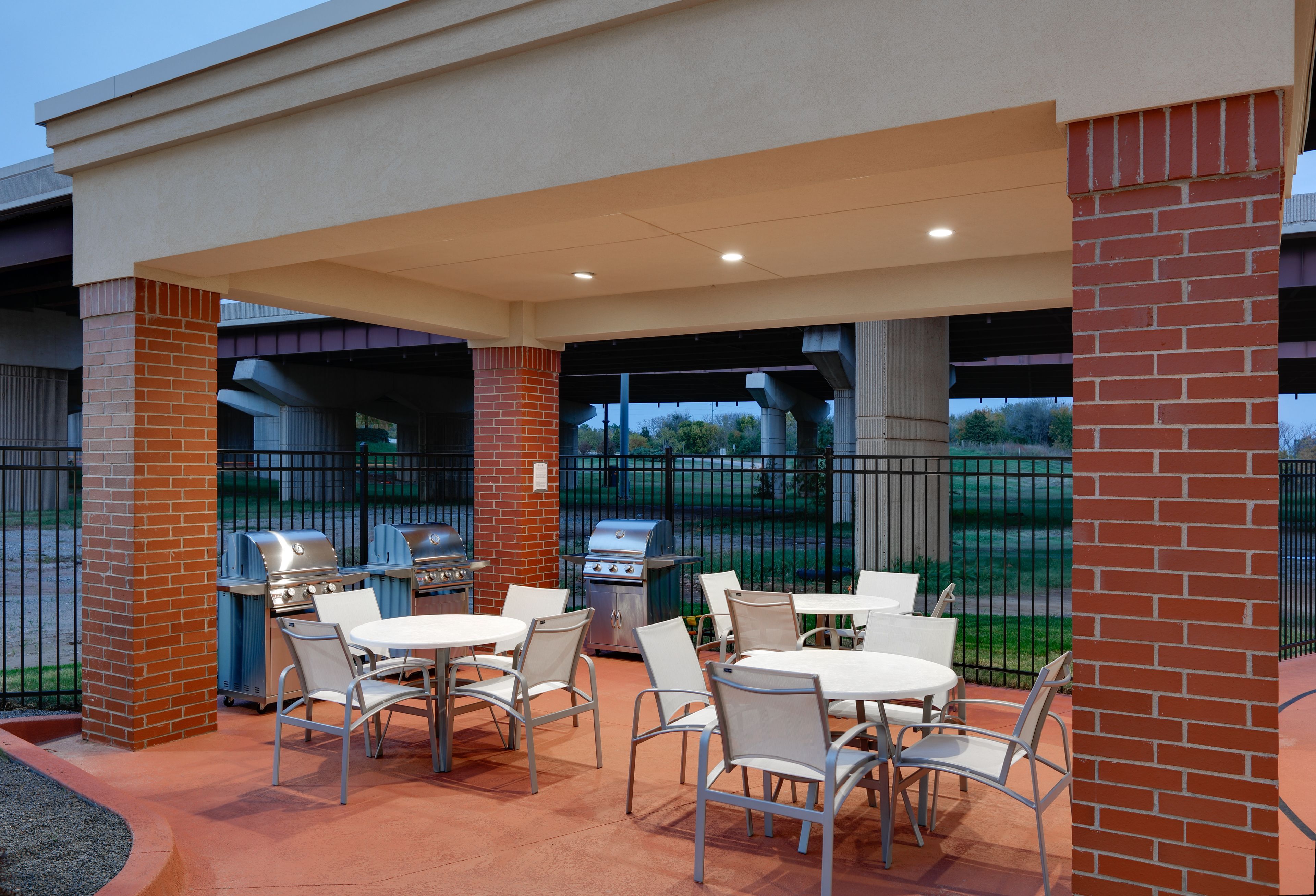 image Inviting outdoor patio with multiple grilling stations and open-air seating.