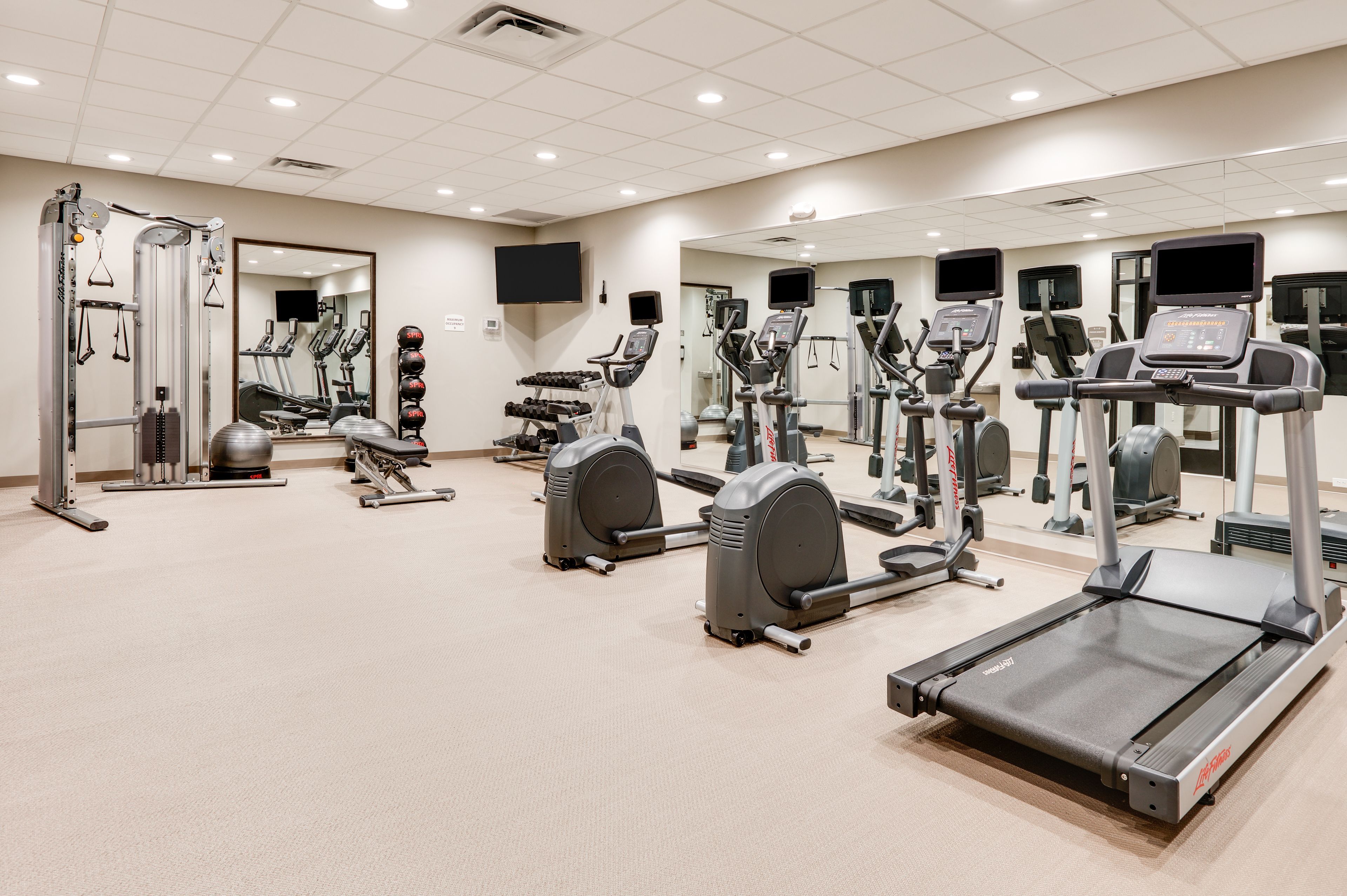 image Fully equipped fitness center with cardio and strength training equipment.