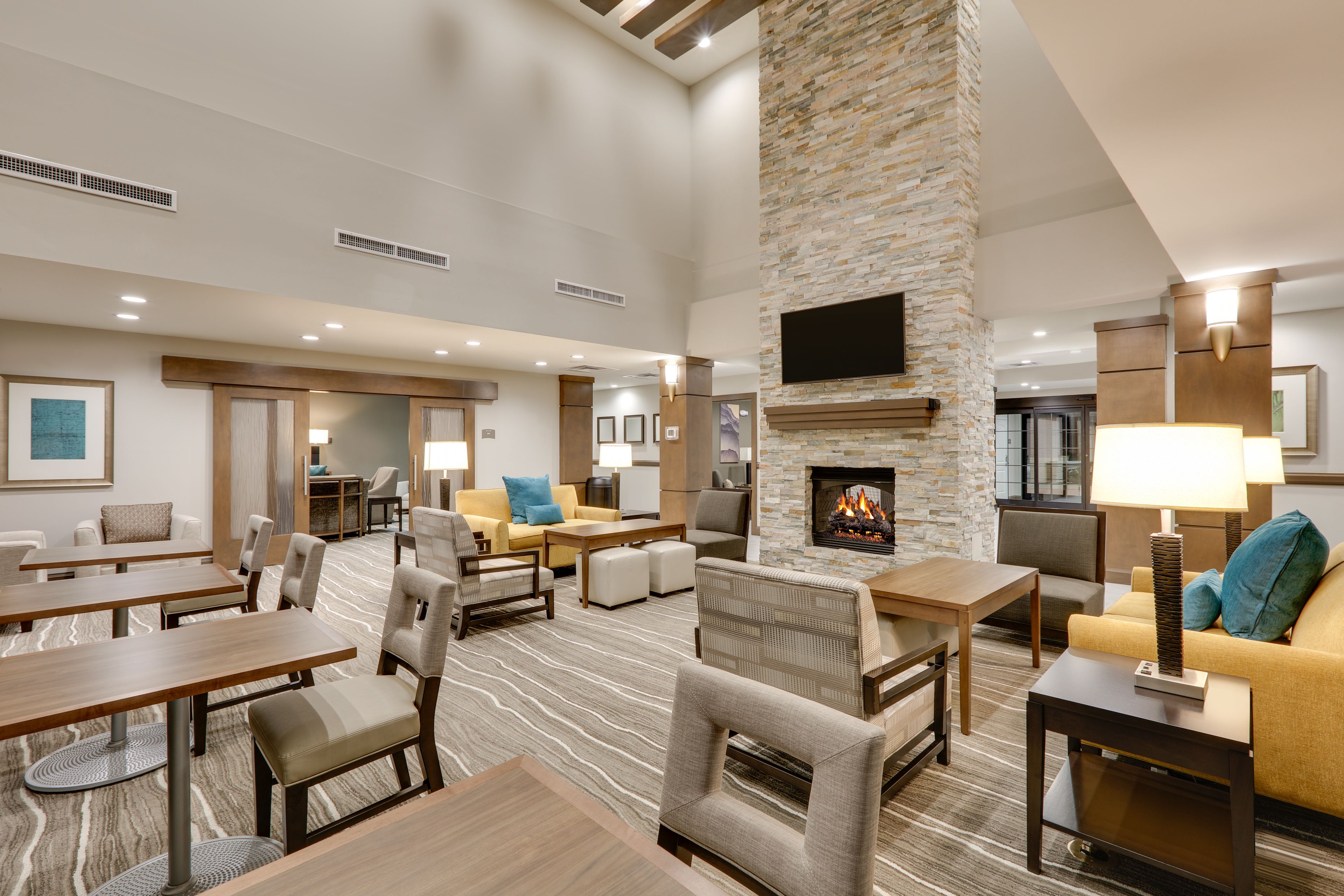 image Cozy lounge with warm fireplace and comfortable seating for guests.