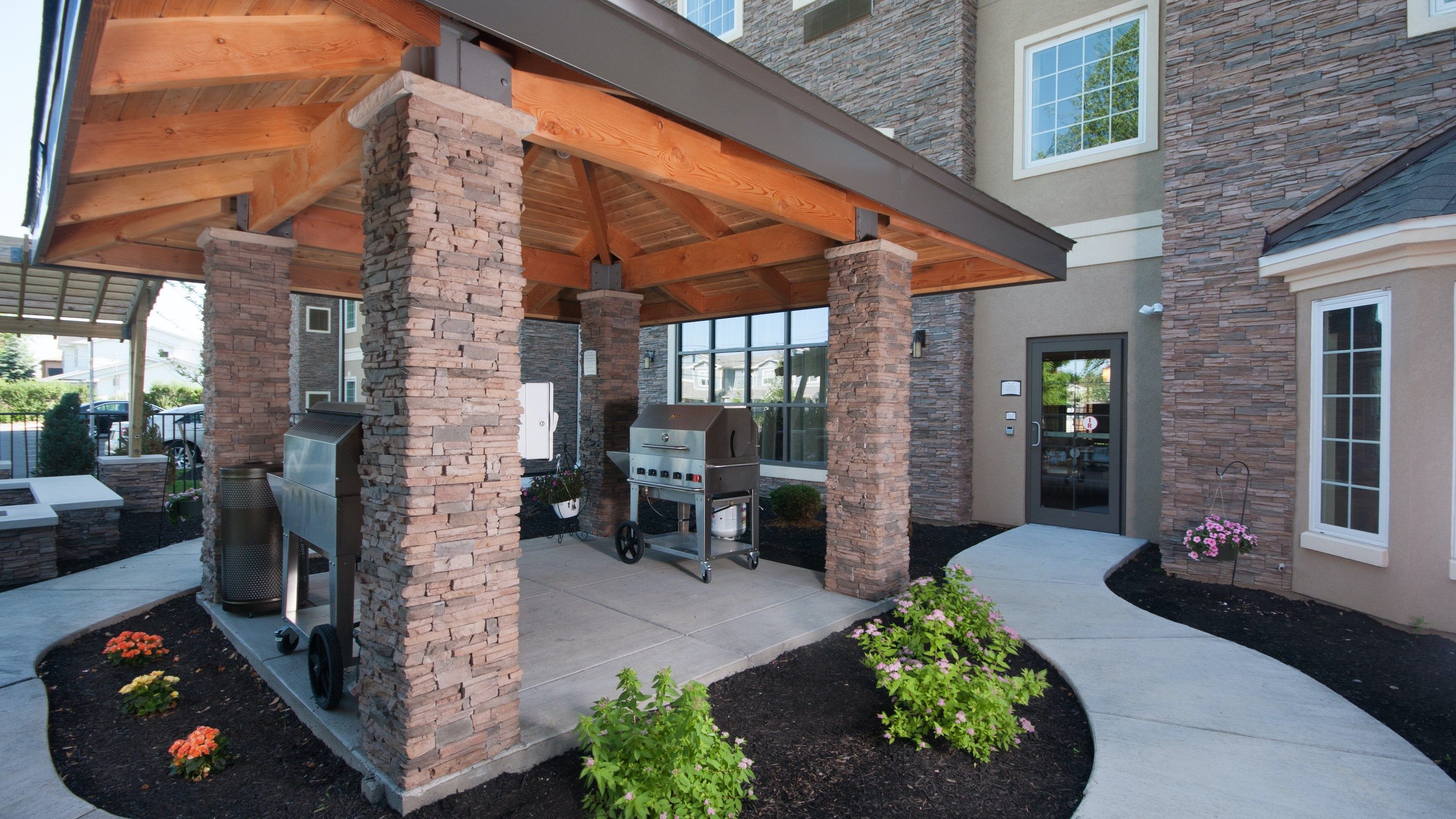 image Outdoor BBQ area with stone pillars and grill