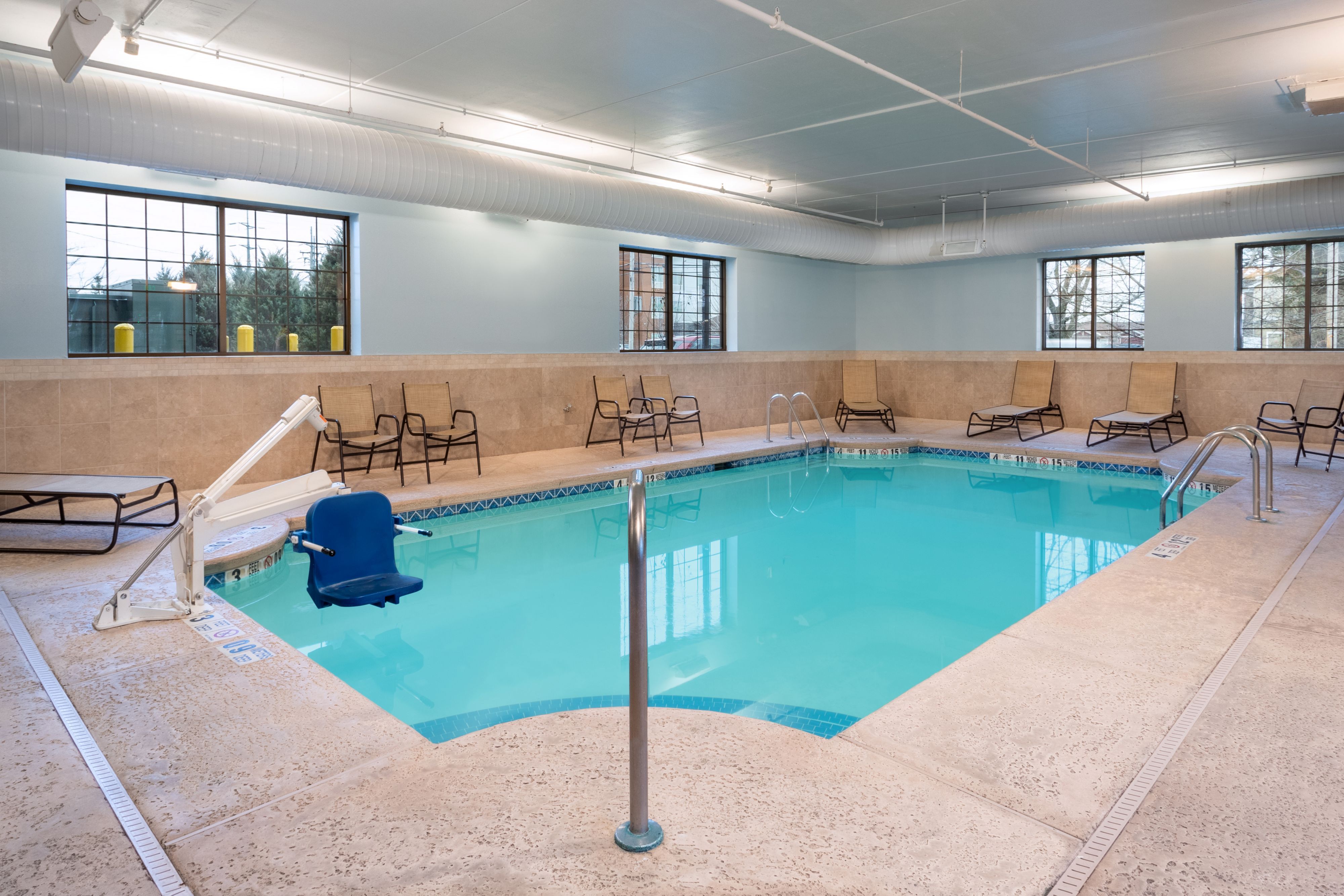 image Poolside lounge chairs soak up the natural light
