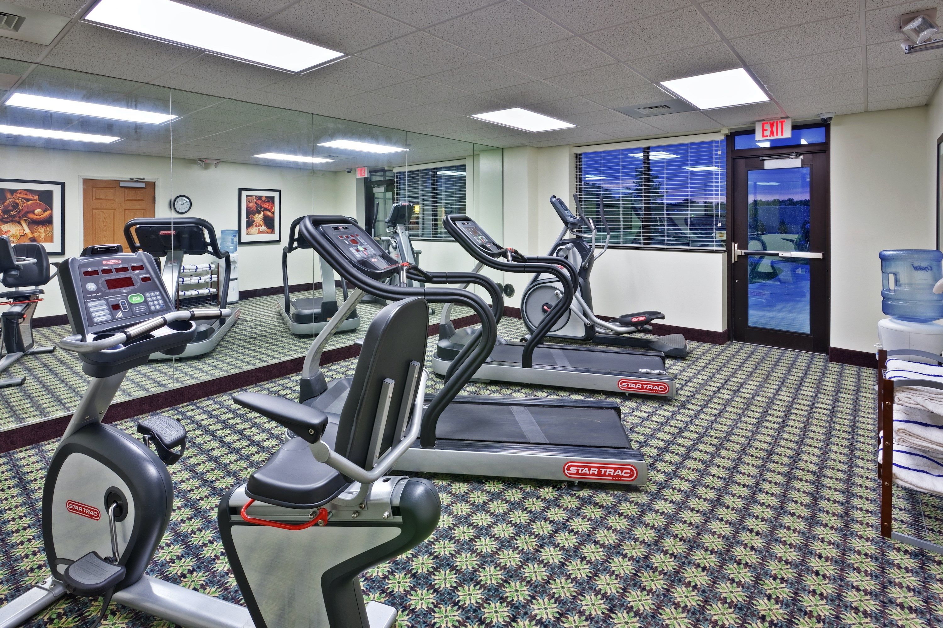 image Gym featuring exercise equipment and large windows.