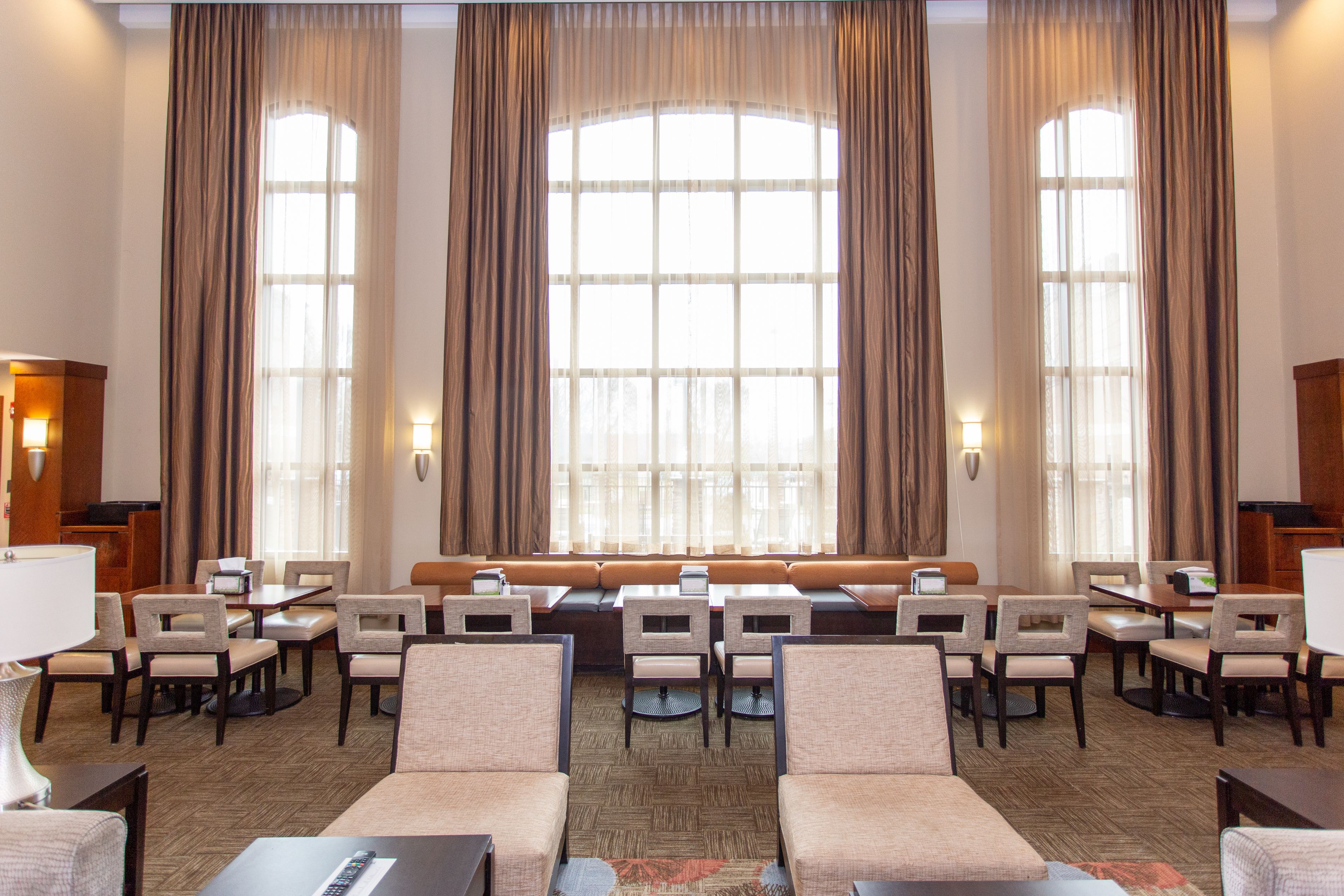 image Large airy lobby with elegant curtains and comfortable seating.