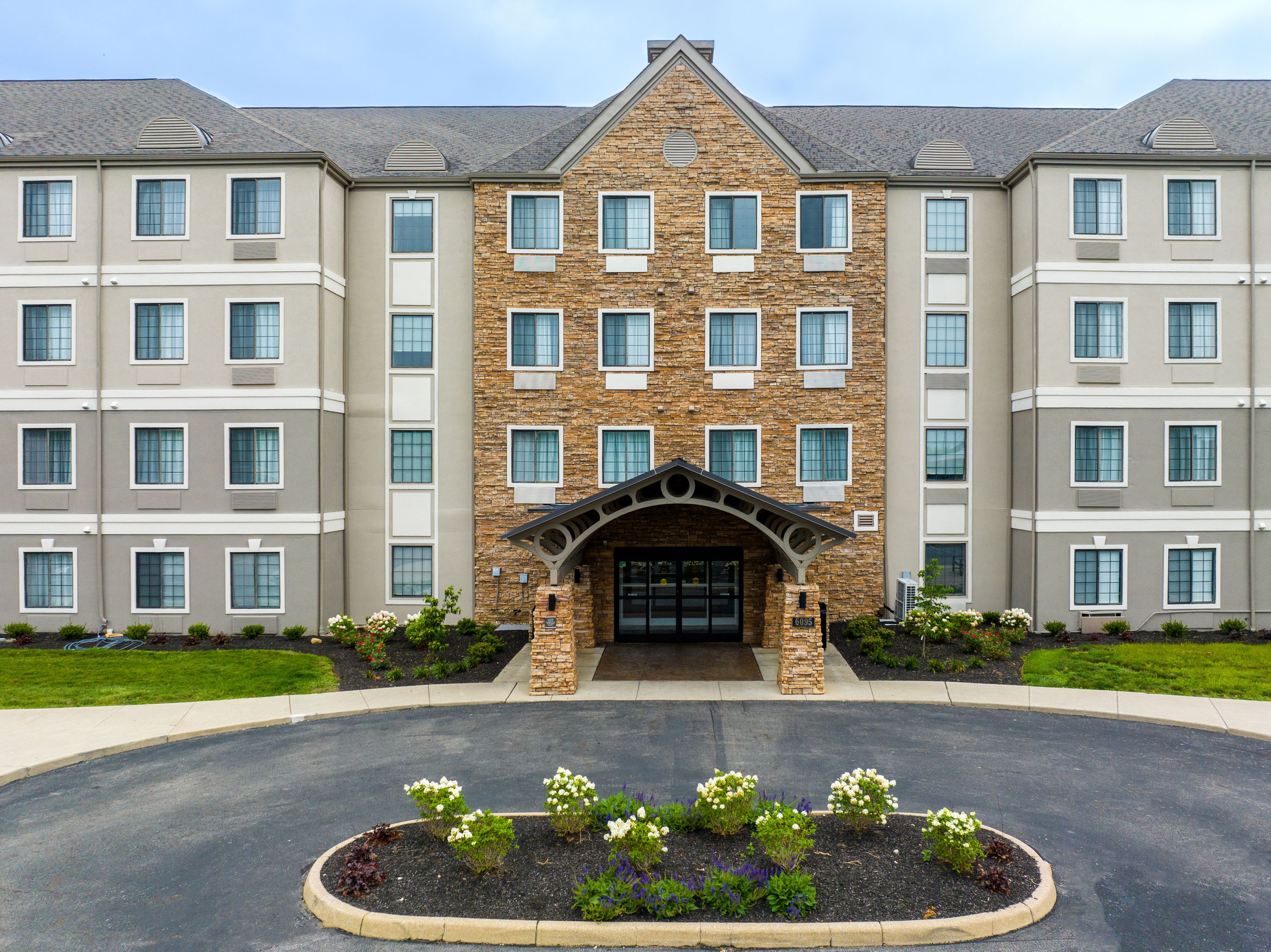 image Hotel exterior with on-site parking and landscaped grounds.