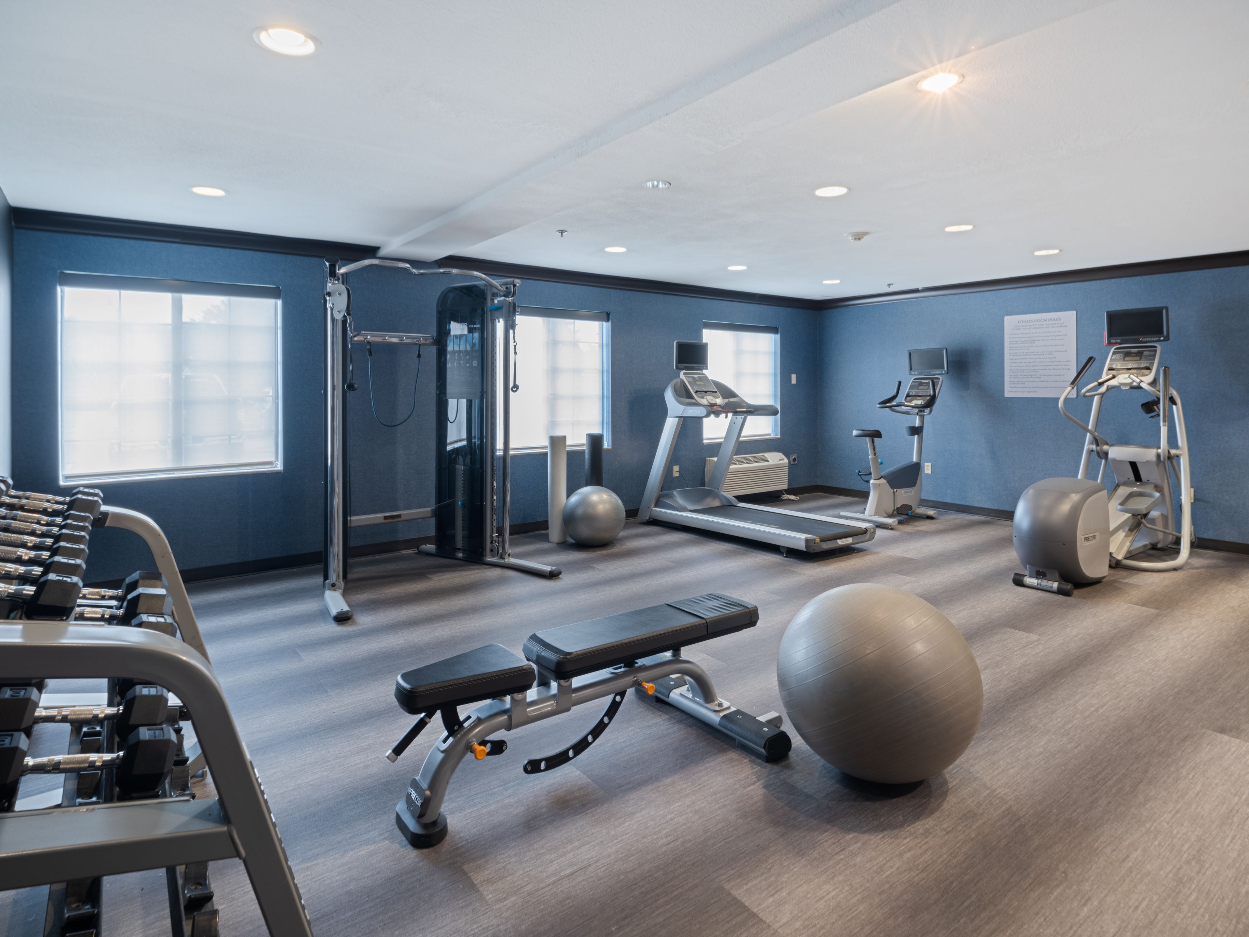 image 24-hour fitness center with cardio and weight training equipment.