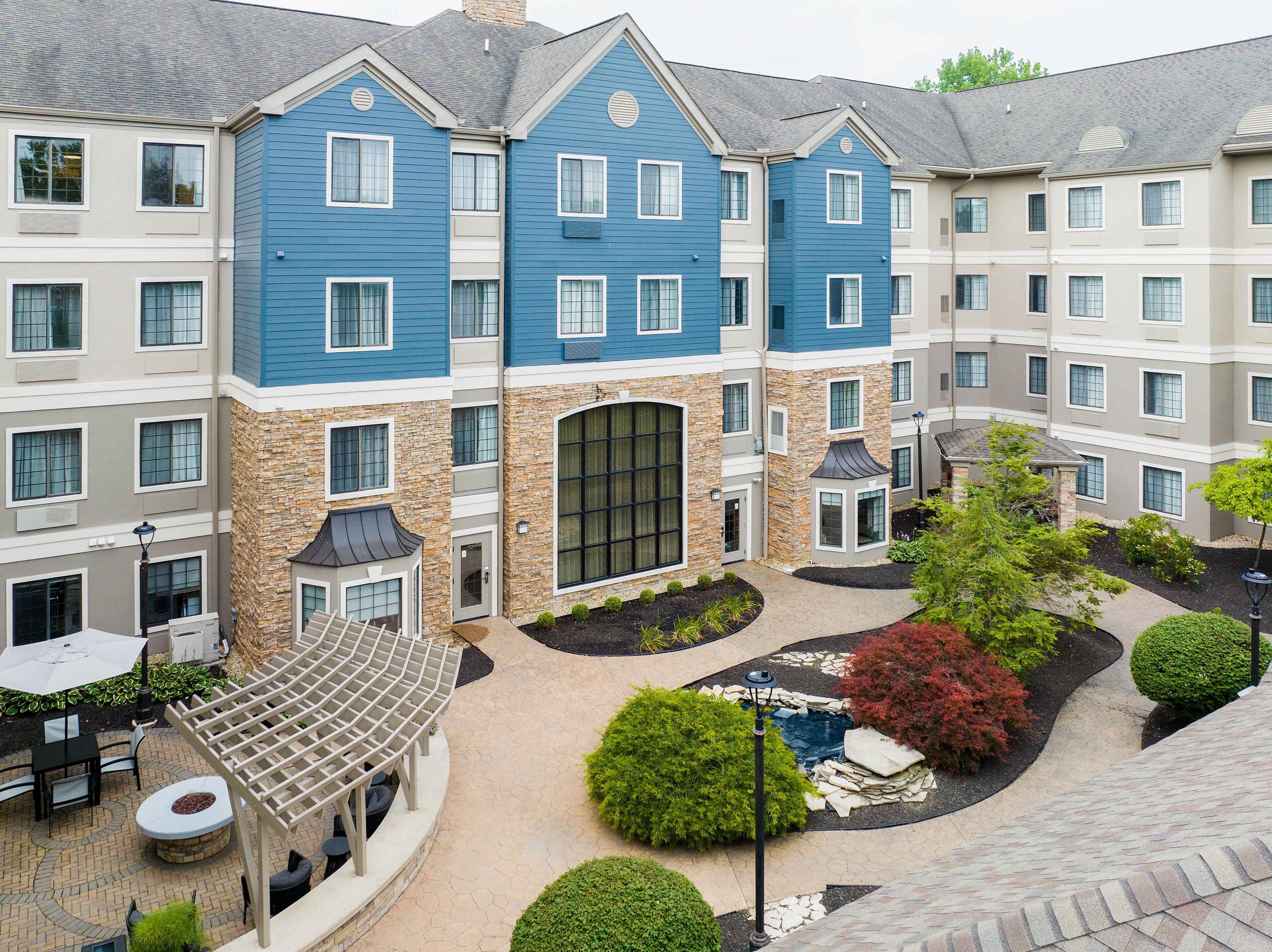 image Landscaped courtyard with seating area and water feature.