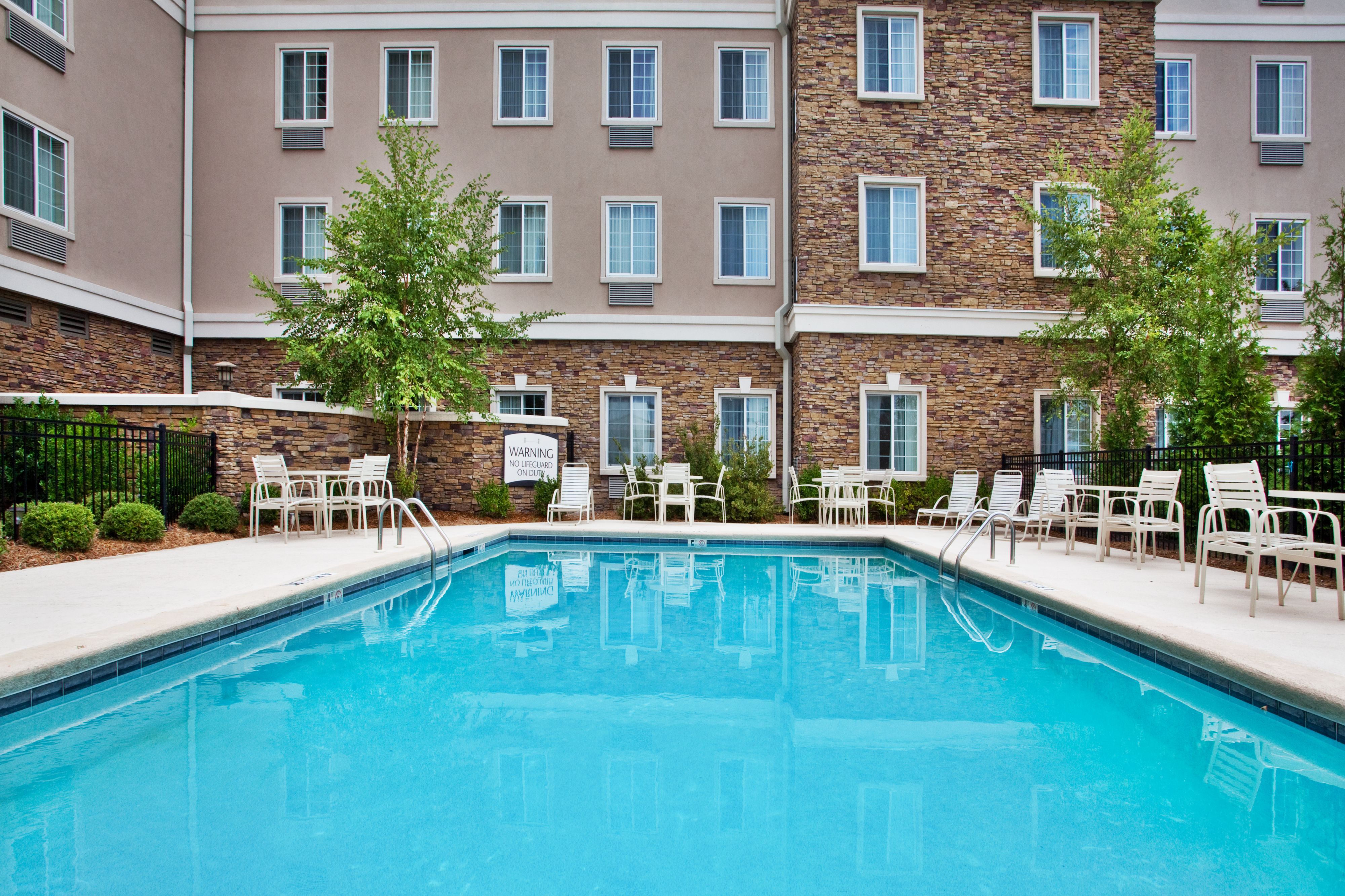 image Take a refreshing dip in the pool, or relax in a chair under the serene atmosphere.