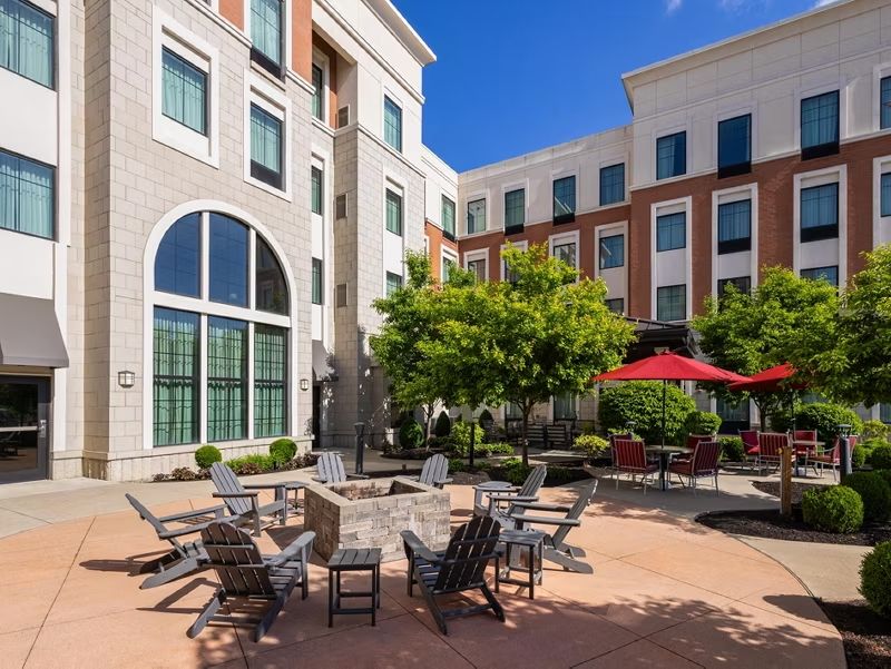 image Unwind by the fire pit in the courtyard, surrounded by lush greenery.