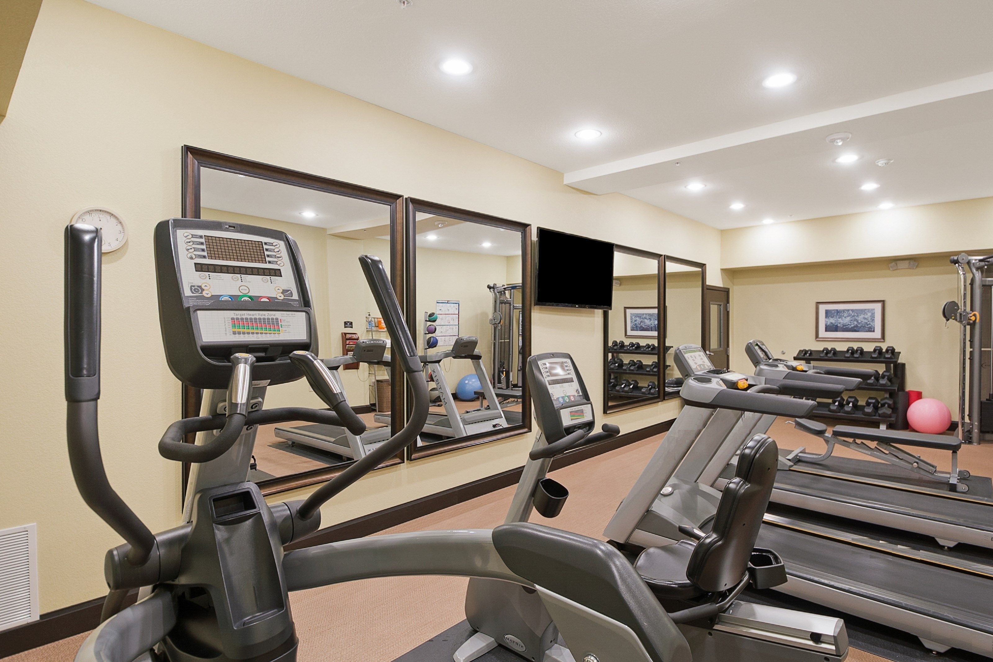 image Break a sweat on modern fitness equipment while staying motivated in a bright space.