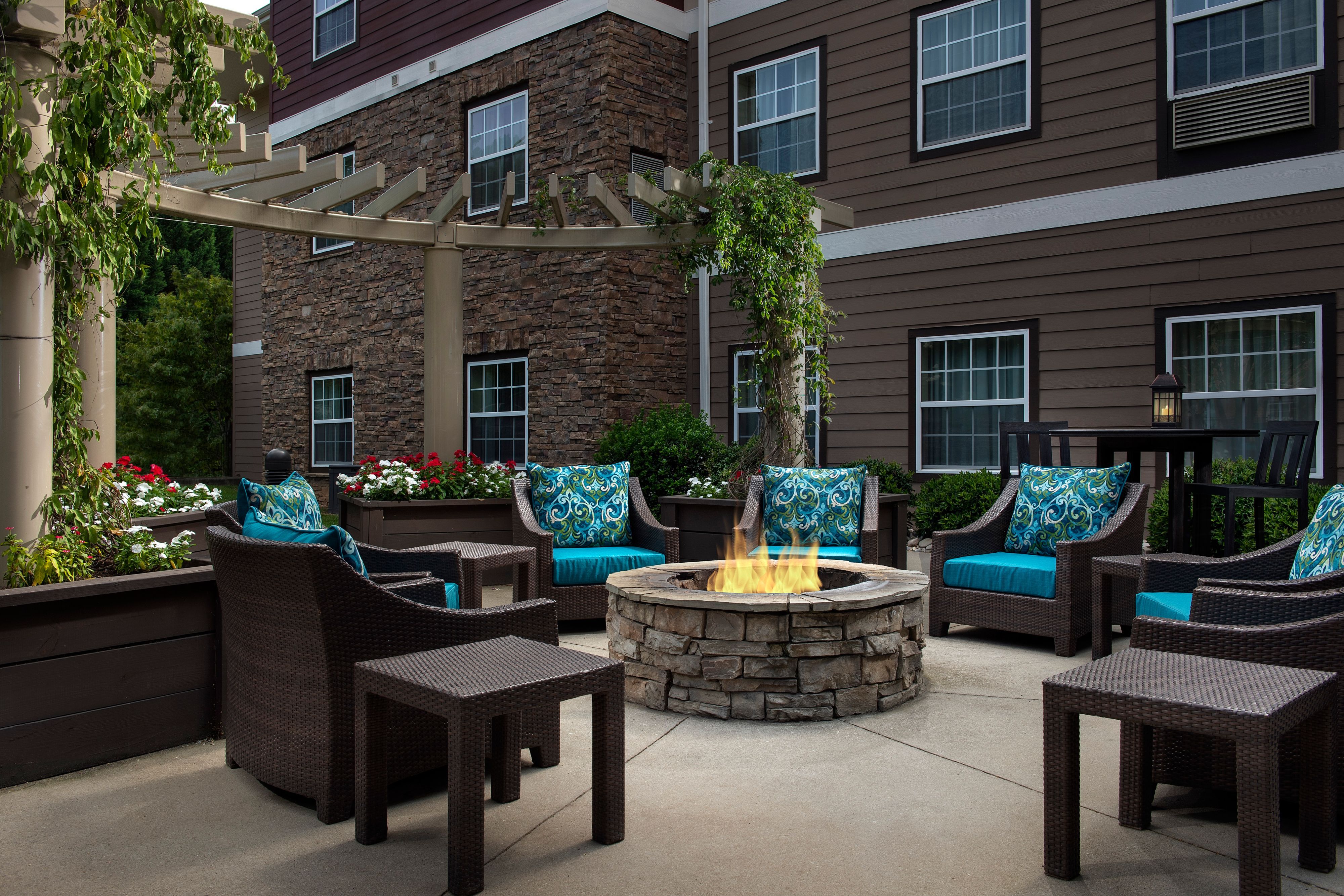 image Outdoor fire pit surrounded by patio seating.