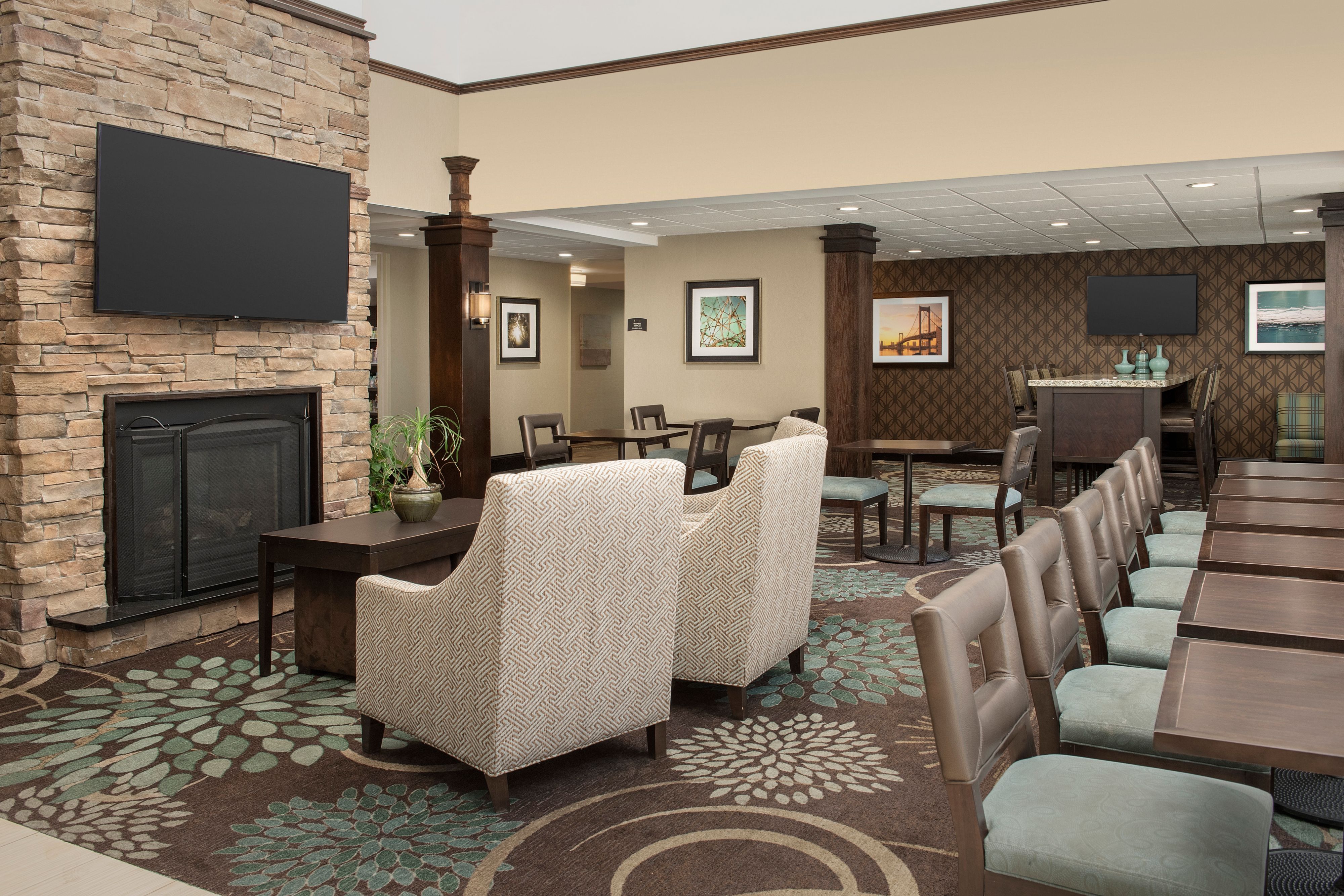 image Common area with seating, fireplace, and wall decor.