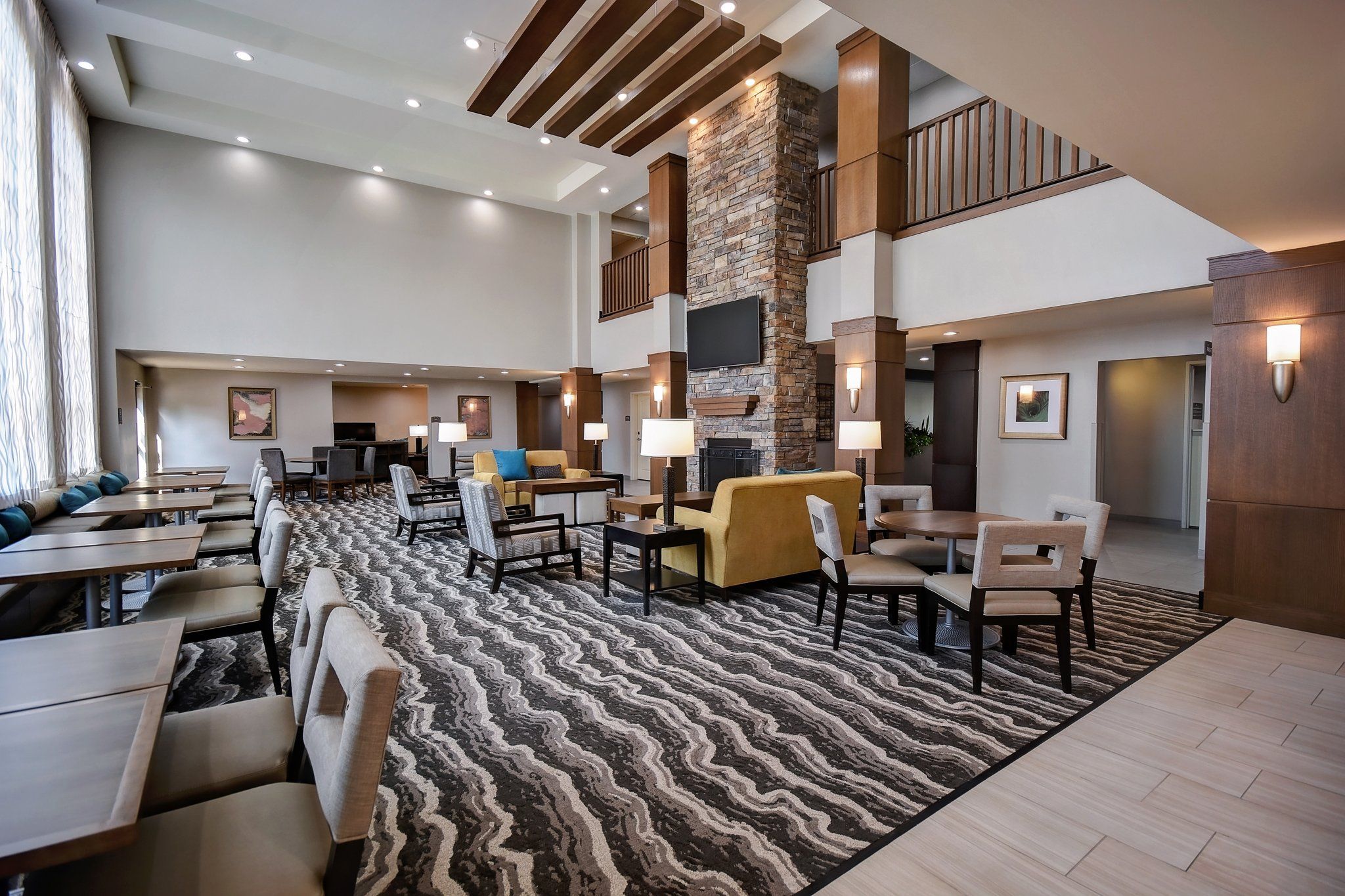 image Unwind in the open-concept lobby lounge with comfortable seating and contemporary design.