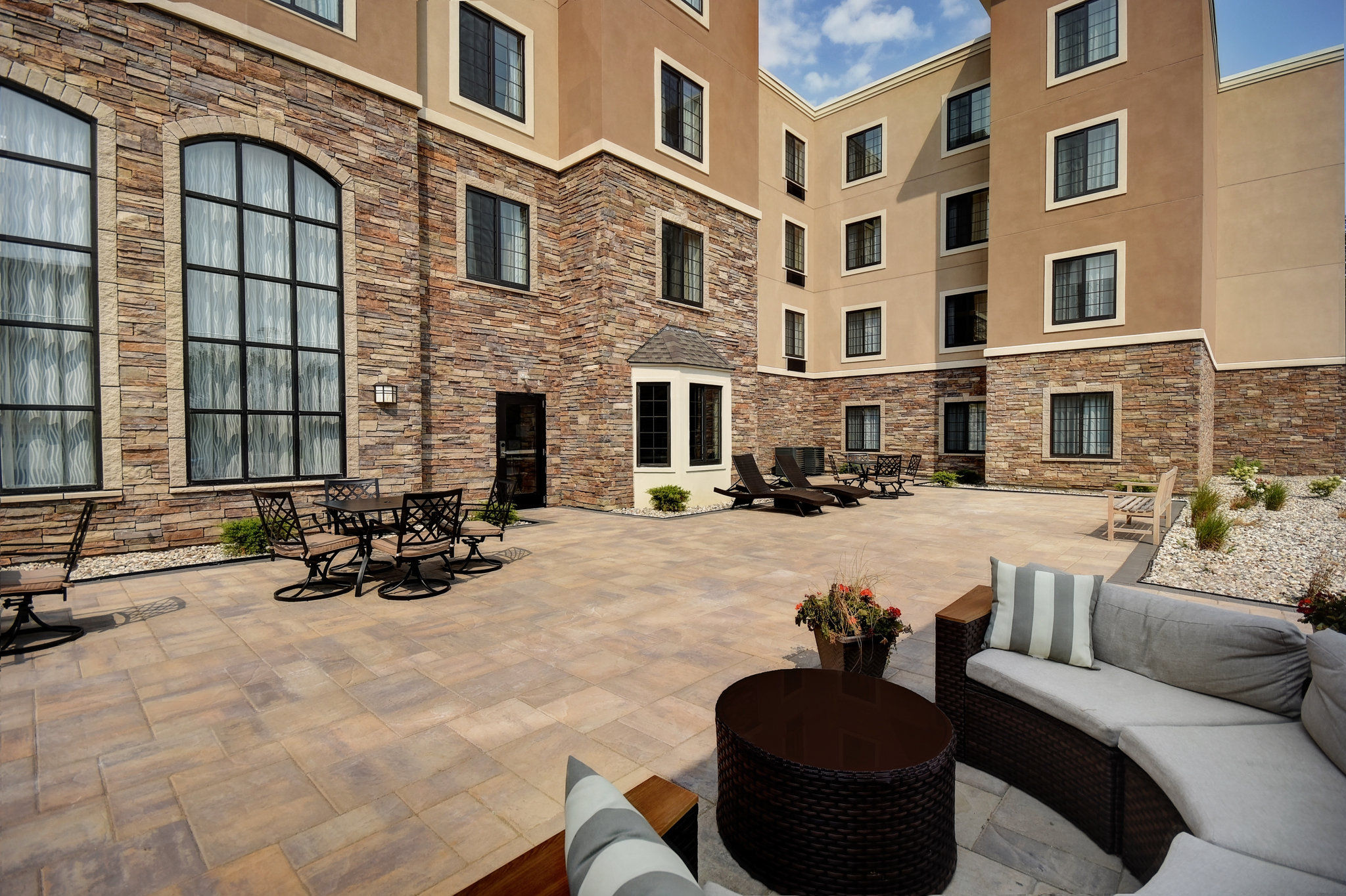 image Outdoor courtyard with seating and a fire feature, perfect for relaxing or socializing.