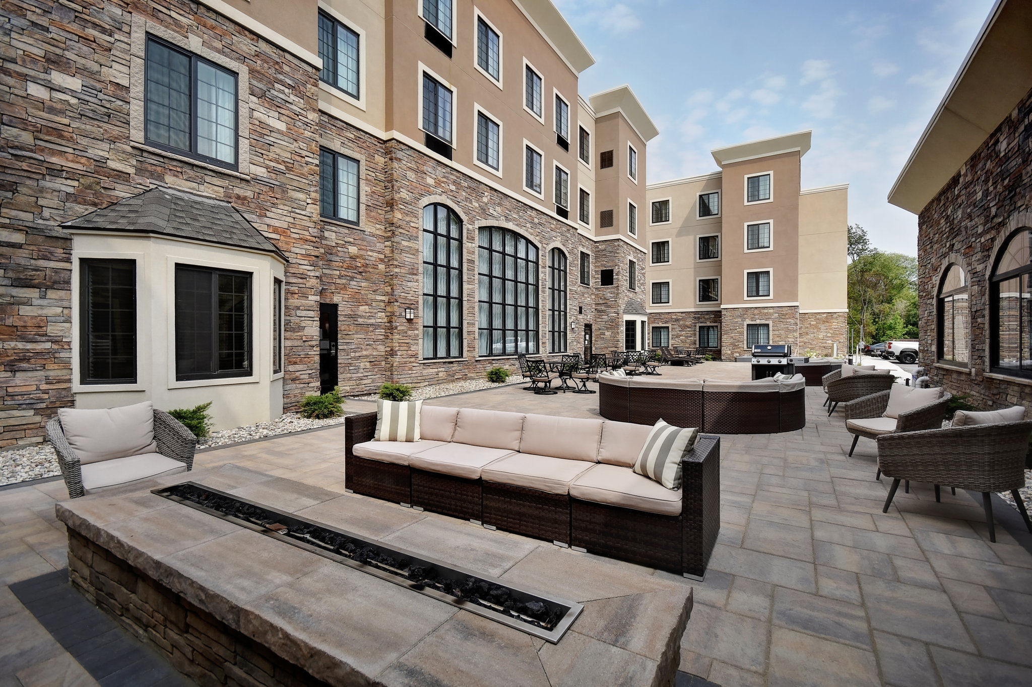 image Comfortable outdoor lounge area with cushioned seating in a private courtyard.
