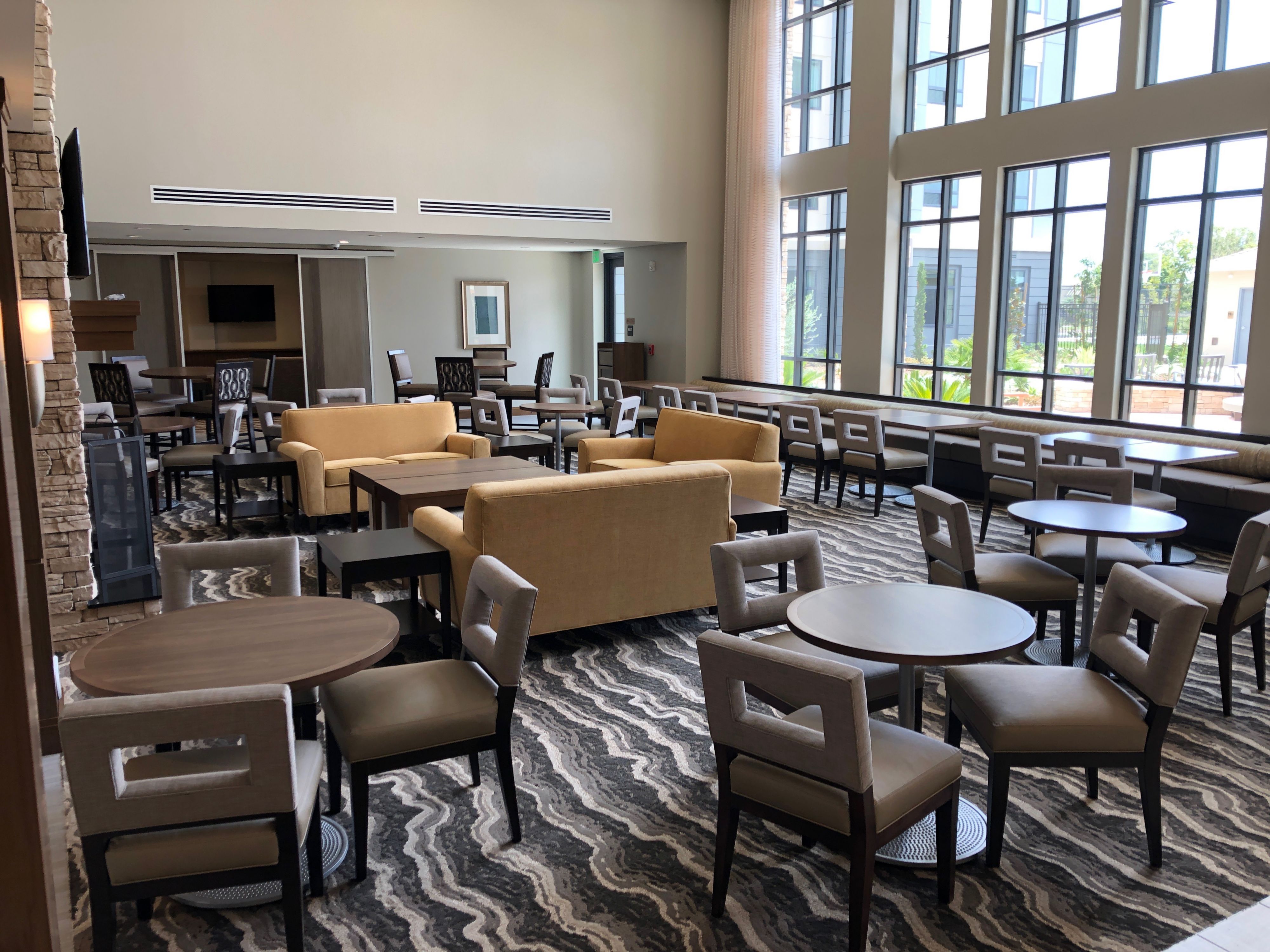 image Spacious lounge area with multiple seating options and a fireplace.