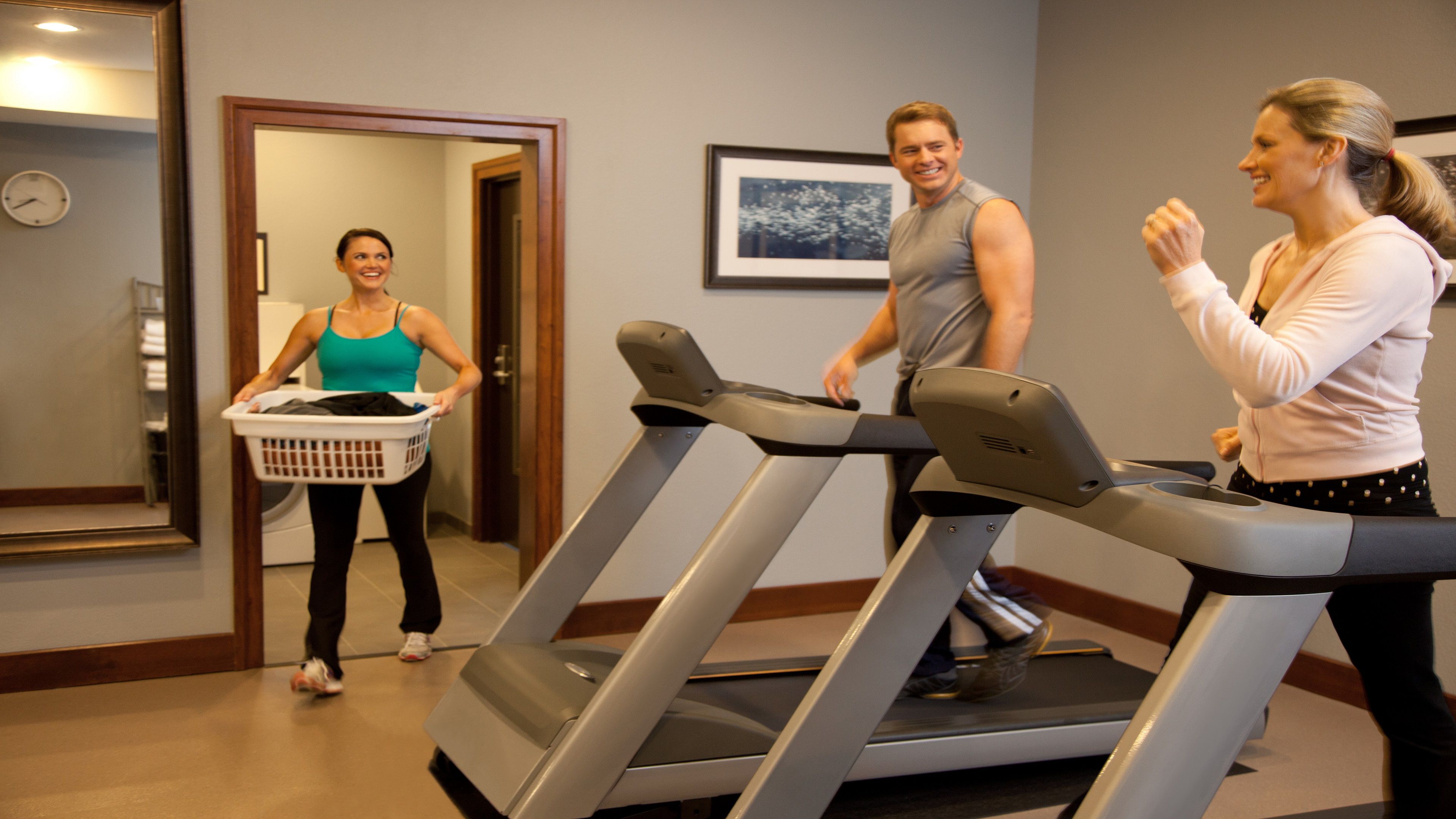 image Well-equipped fitness center with cardio machines, free weights, and flat-screen TV.