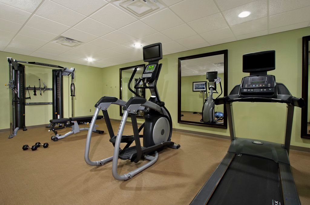 image Fitness center with cardio machines and exercise equipment.