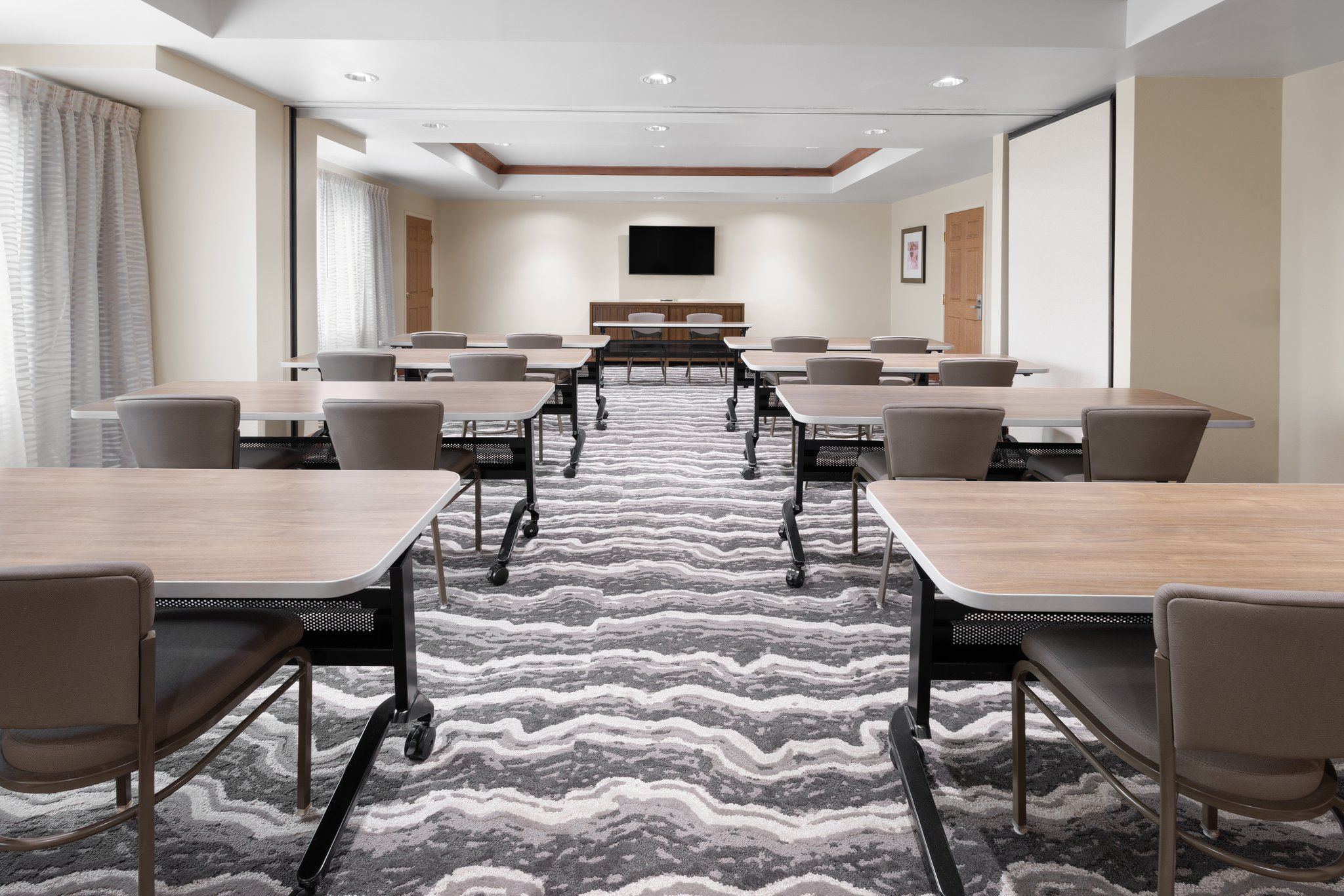 image Spacious meeting room with versatile seating and natural light.