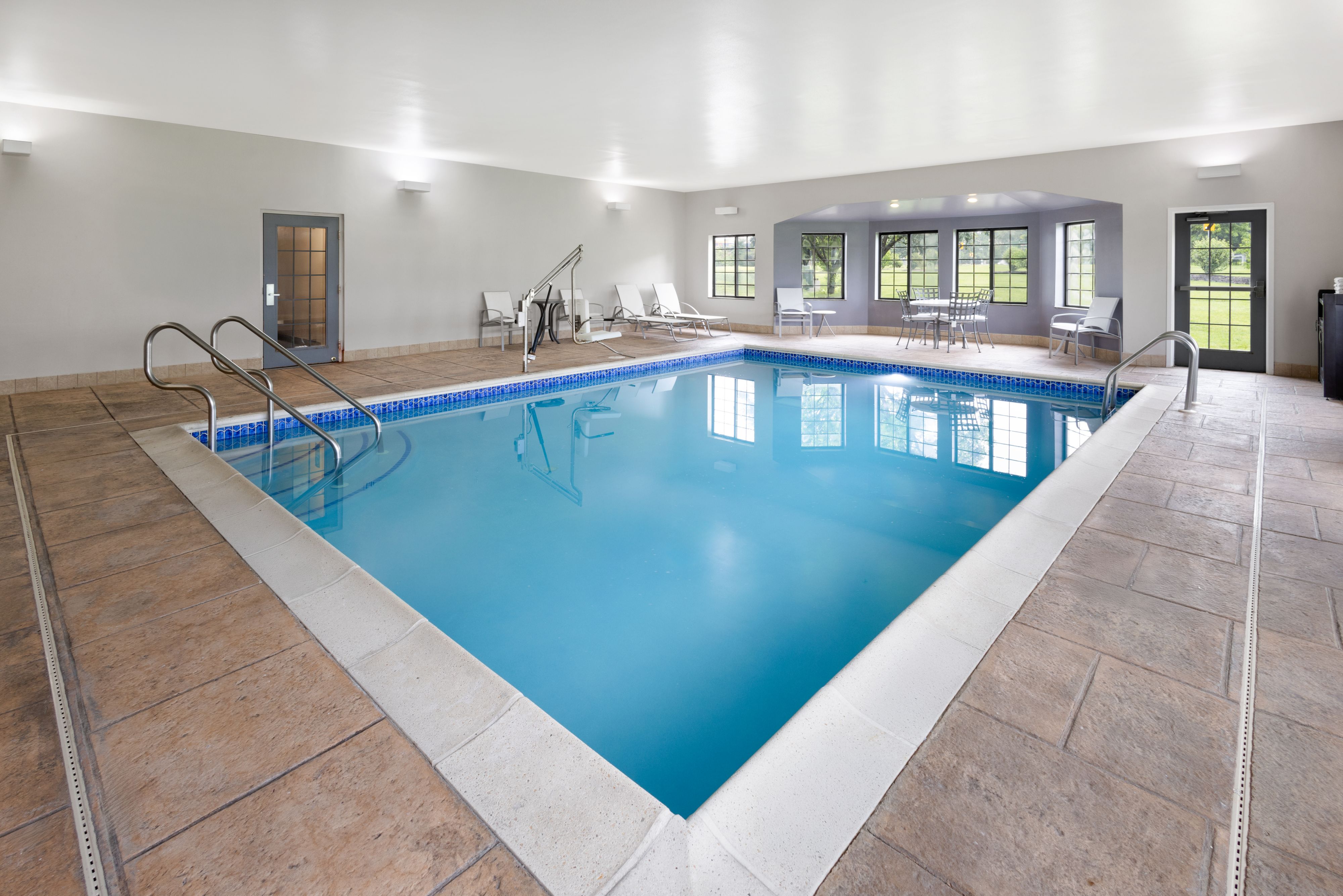 image Refreshing indoor pool available for guests throughout the day.