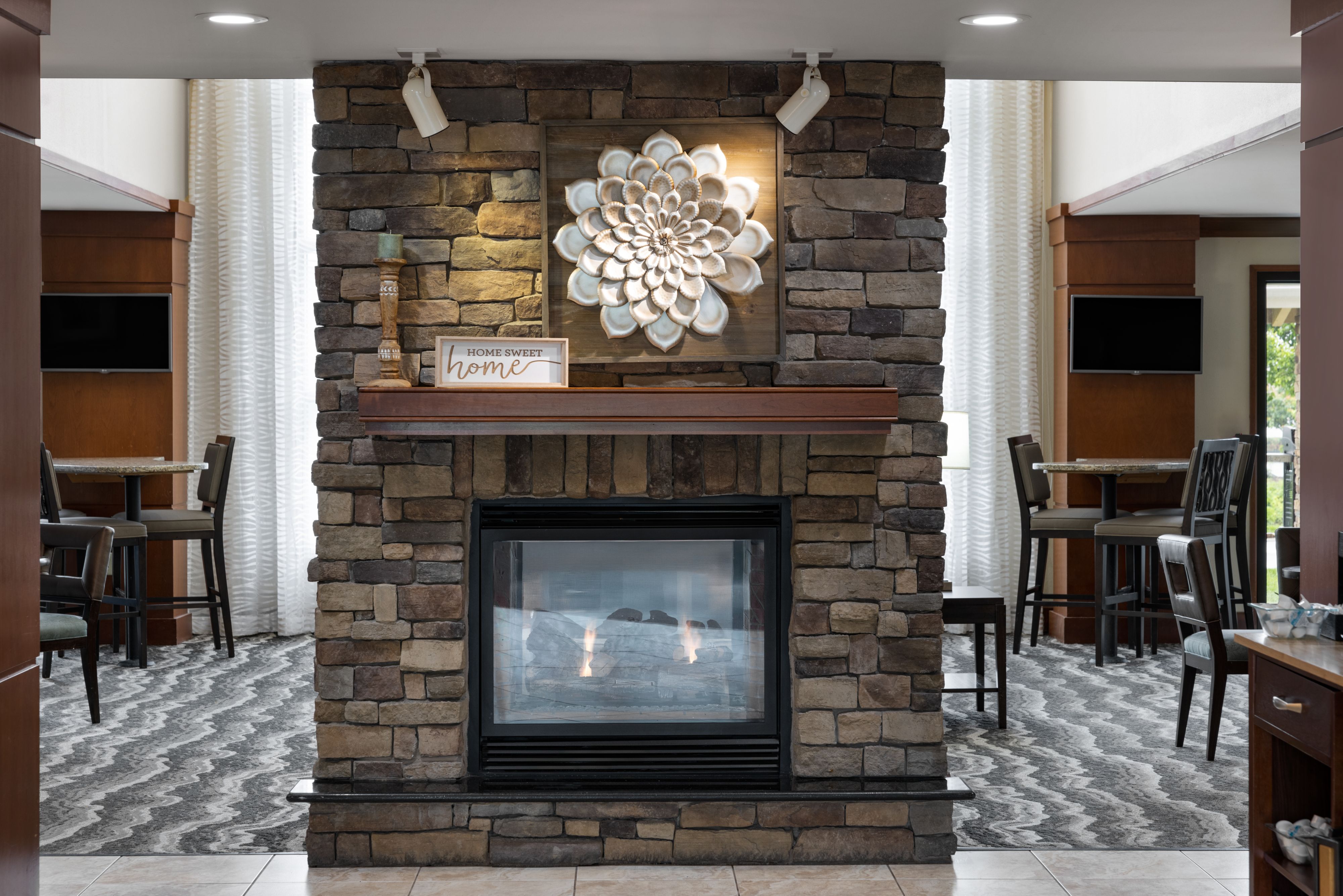 image Stylish fireplace lounge surrounded by cozy seating for guests.