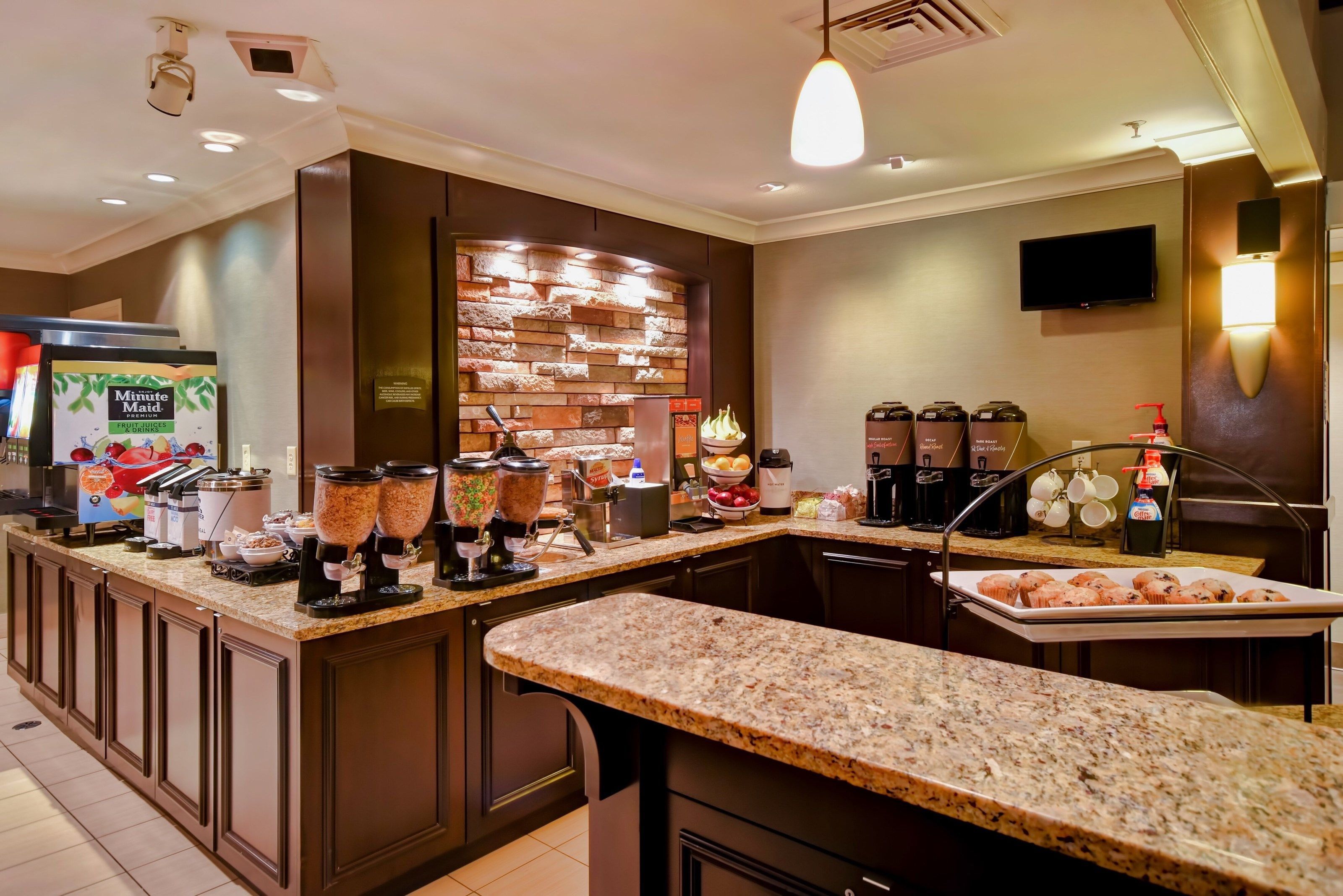 image Breakfast area with cereals, pastries, and beverages