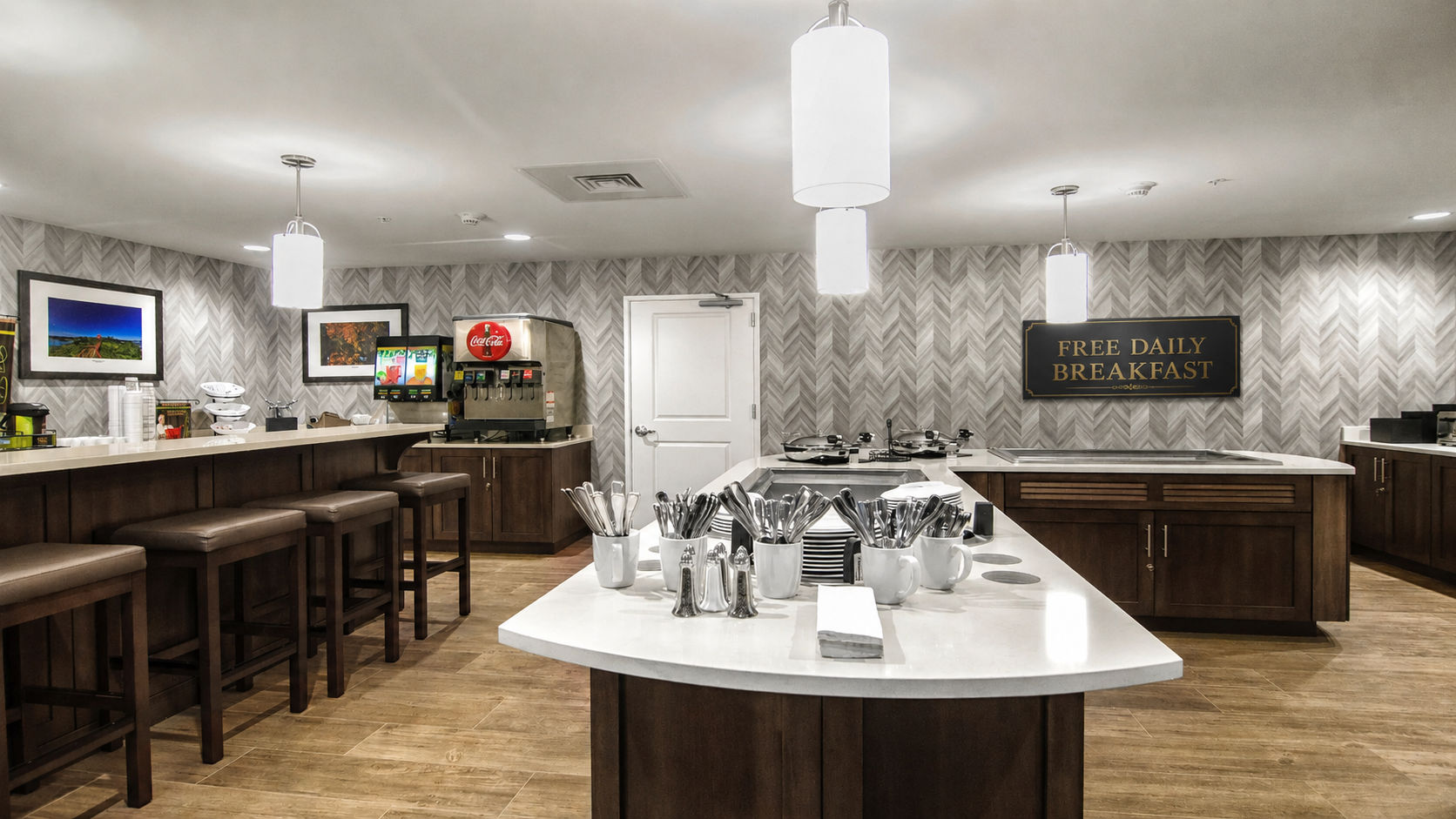 image Complimentary breakfast area with buffet stations and dining seating.