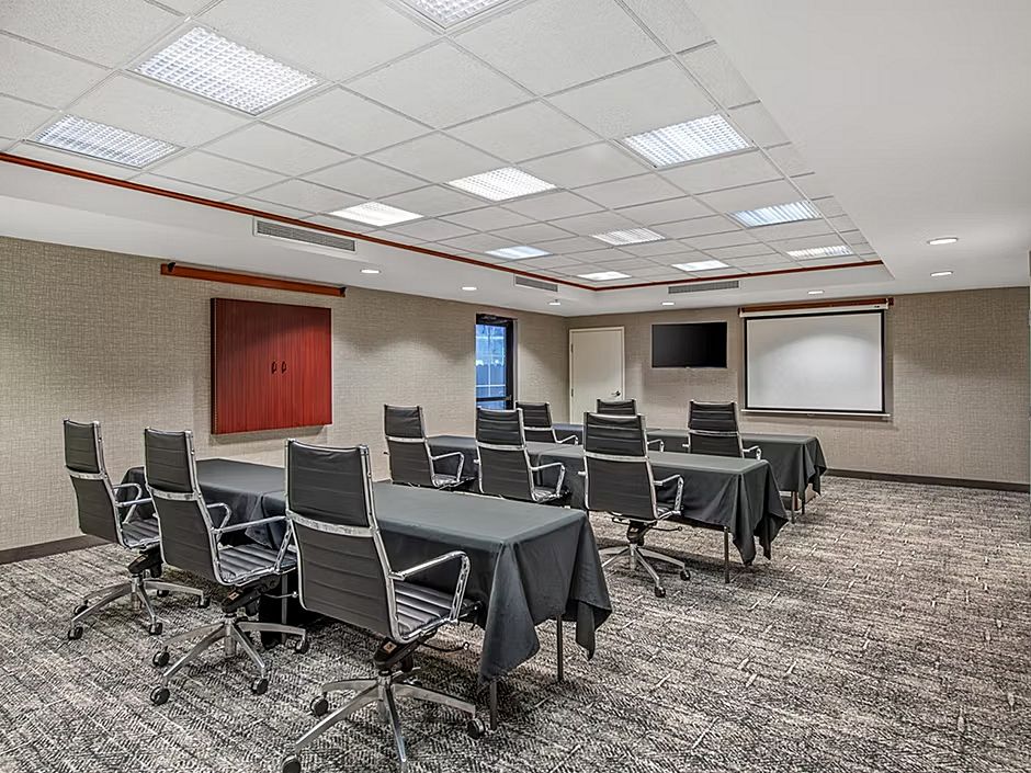 image Flexible seating and a projector setup make this meeting space ideal for productive sessions.