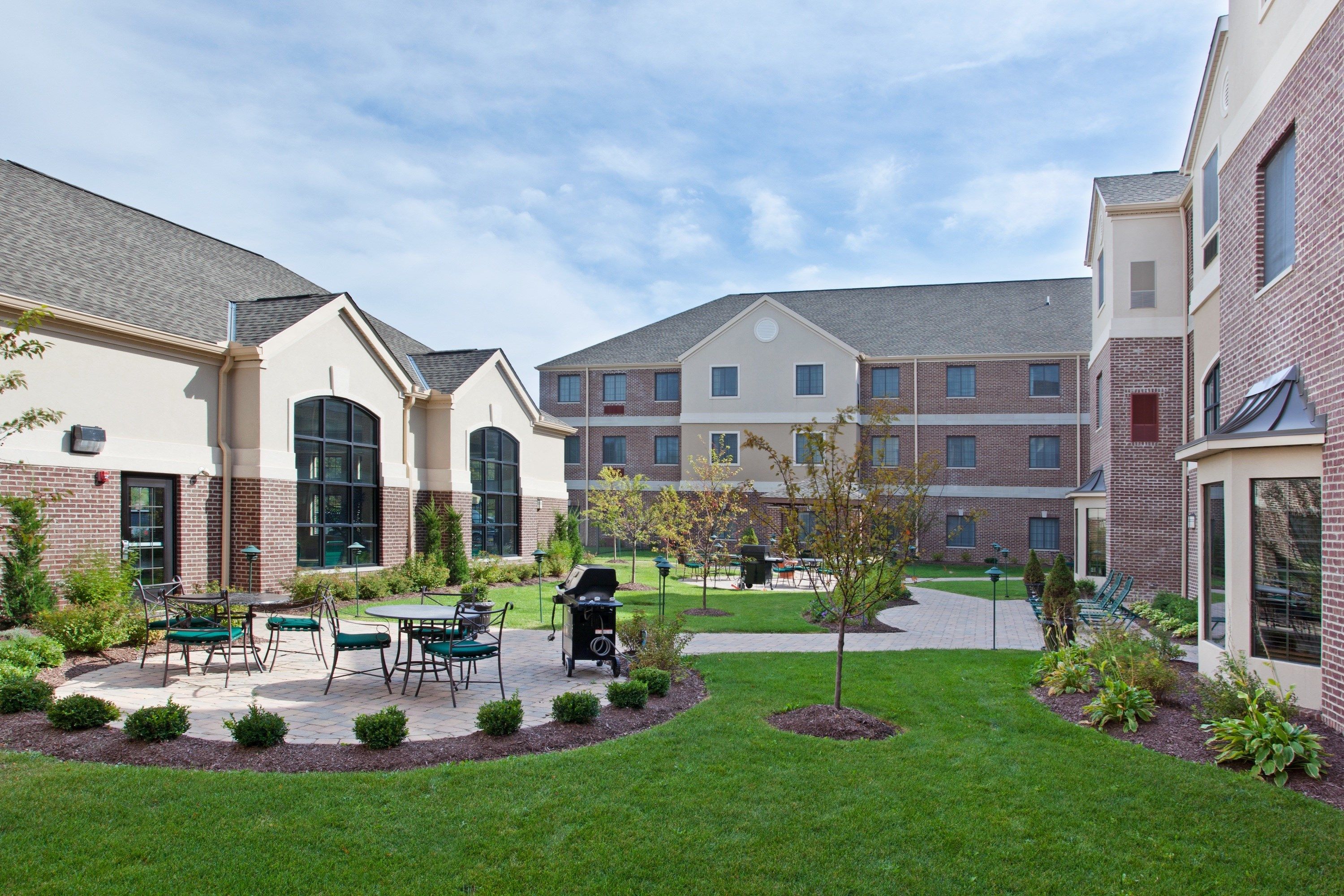 image Landscaped courtyard with seating areas and walkways — a relaxed space to sit and unwind outdoors