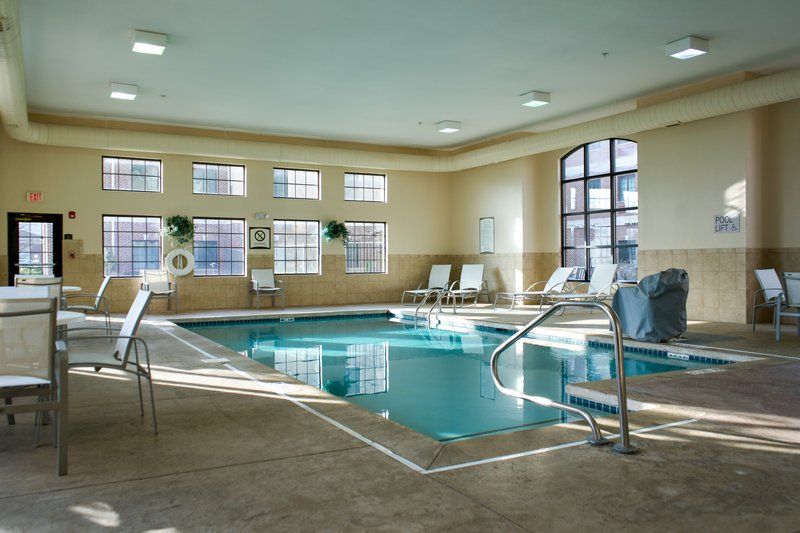 image Heated indoor pool with blue tile surround — open daily 7:00 AM to 11:00 PM for guests