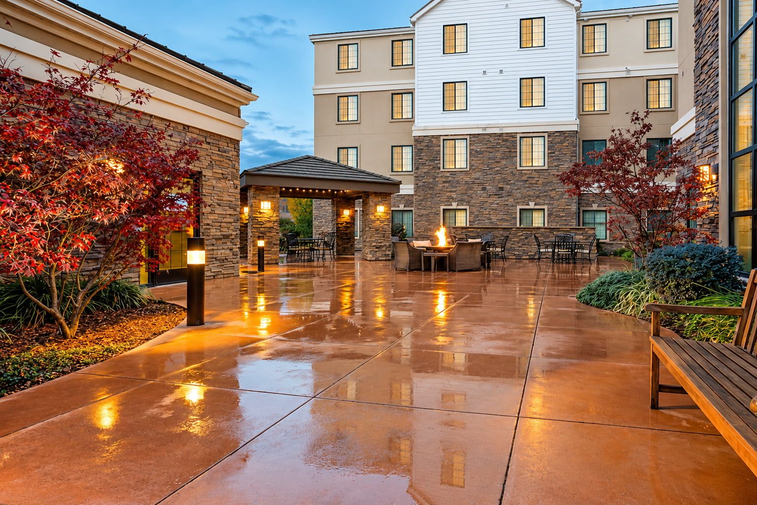 image Spacious courtyard with a fire pit, outdoor seating, and potted plants.