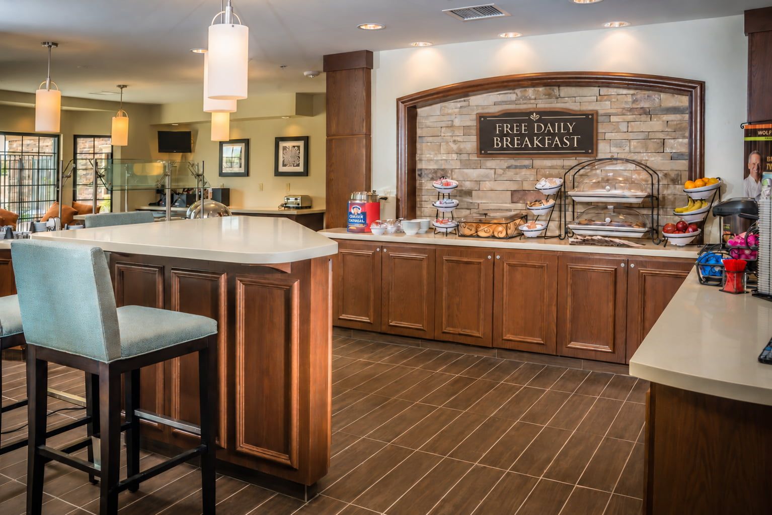 image Breakfast dining area with food display and counter seating.
