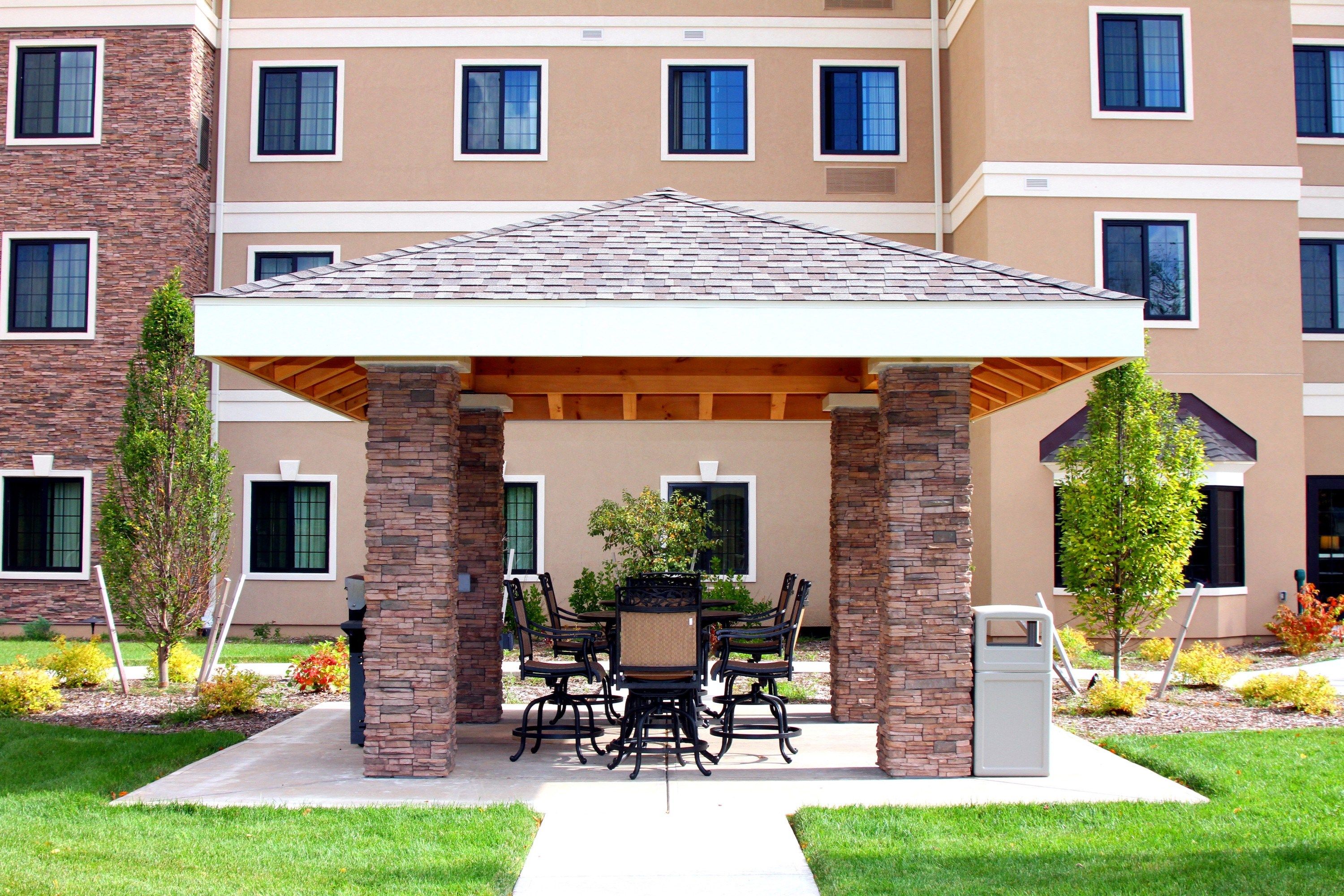 image Covered outdoor patio with tables and chairs.