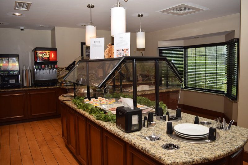 image Breakfast serving counter with glass display case and beverage station