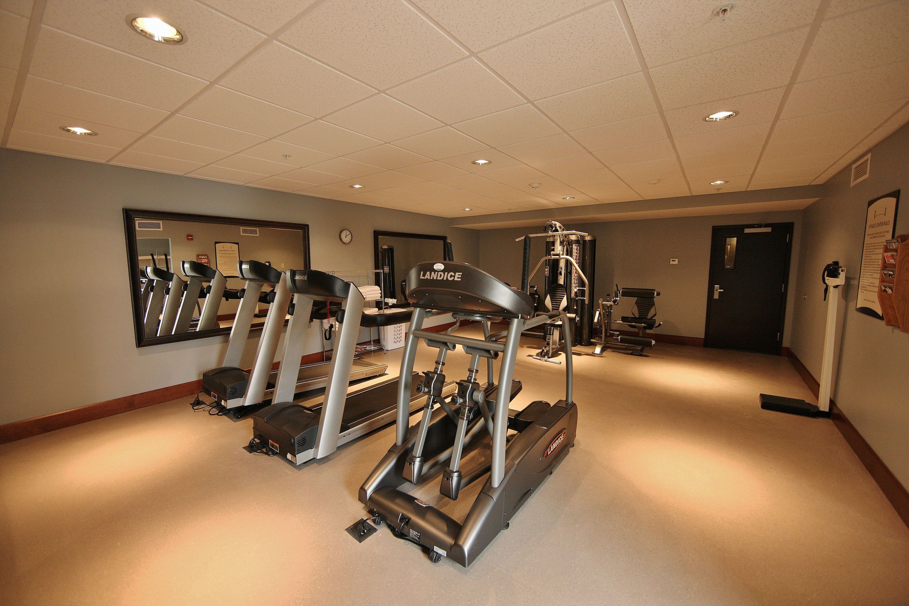 image Fitness room featuring treadmills and cardio machines.