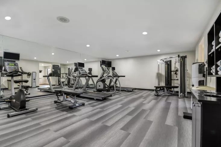 image Fitness center with treadmills, ellipticals, and free weights — open to all guests