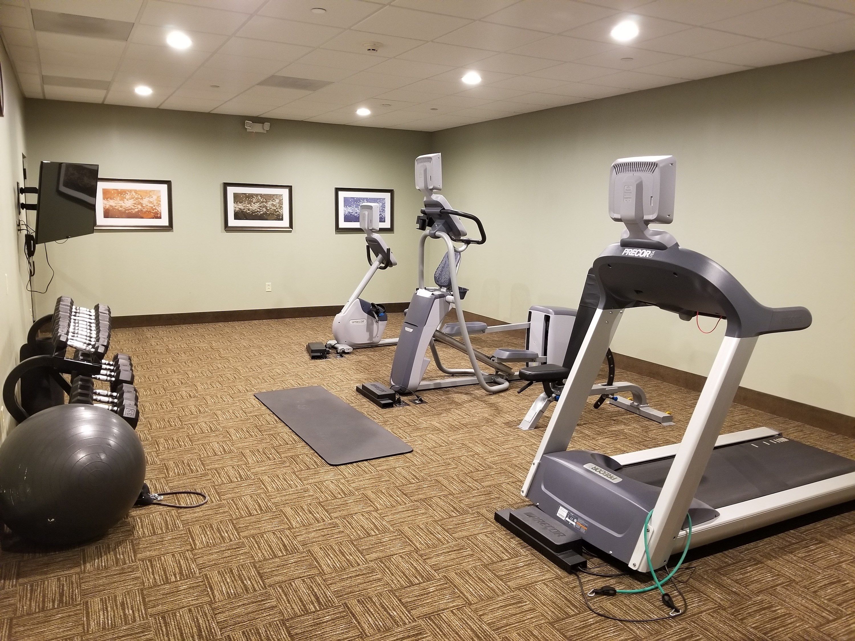image Fitness center with cardio machines and weight equipment.