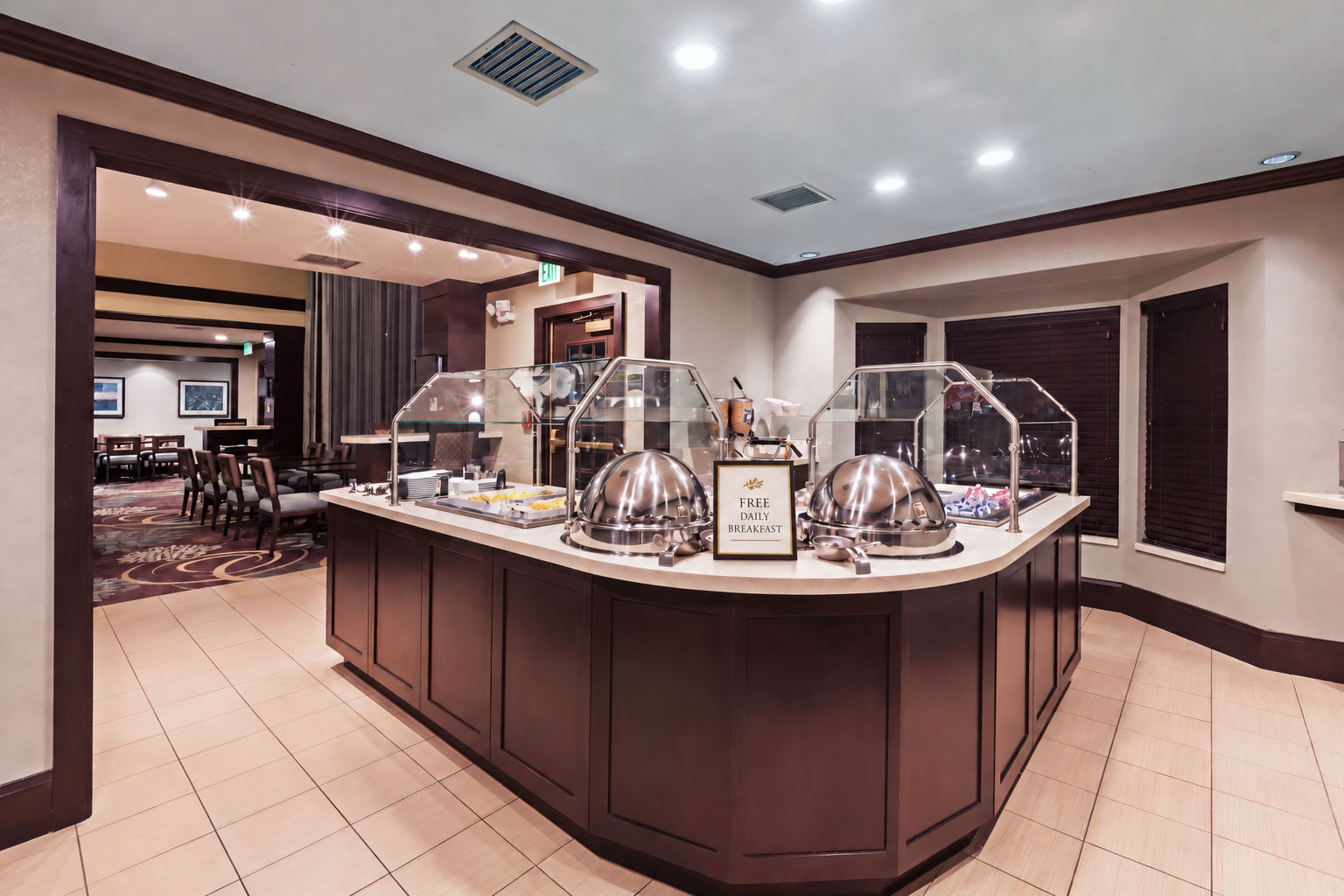 image Breakfast bar area with multiple tables and artwork on walls