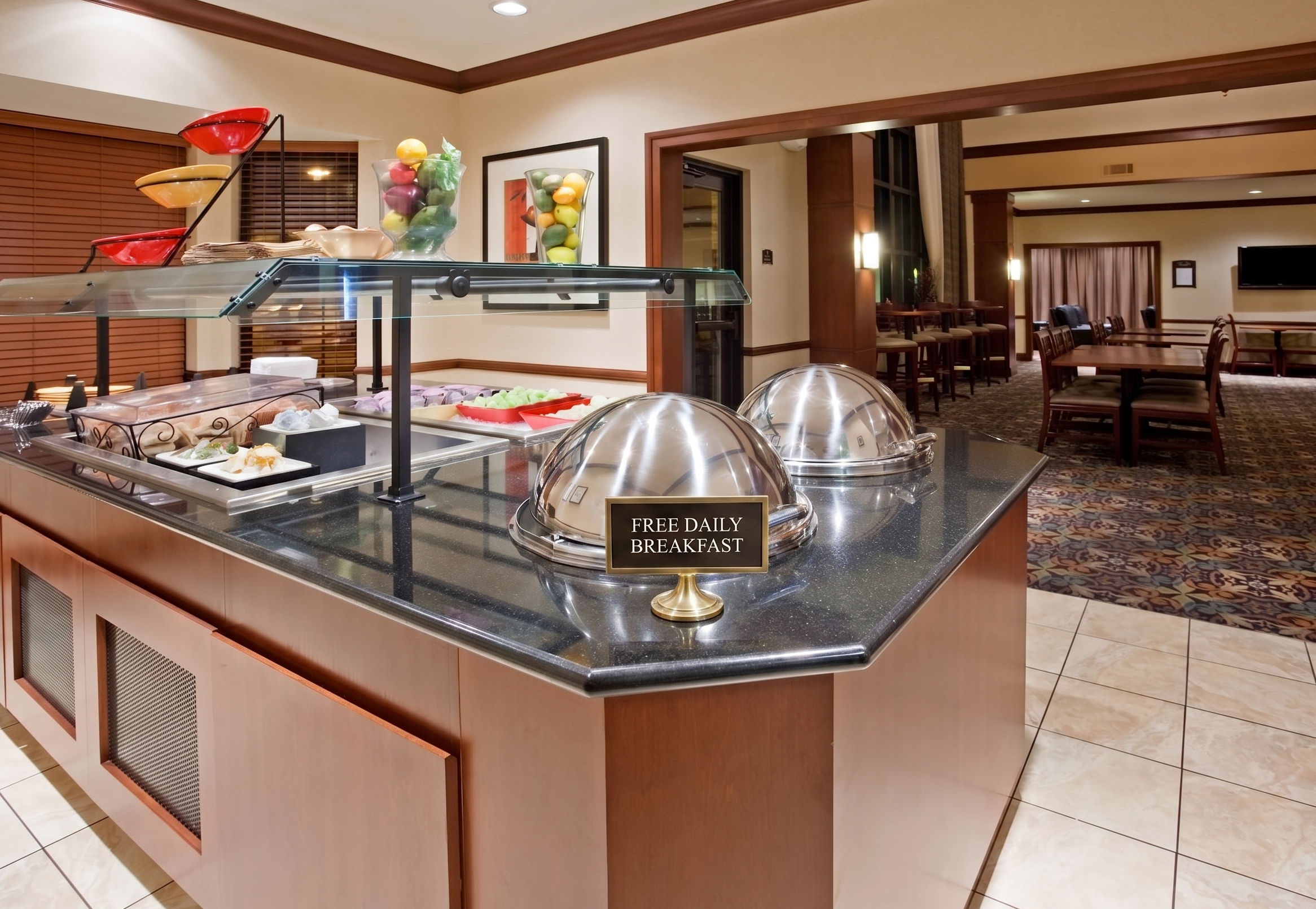 image Complimentary breakfast buffet with fresh fruits and hot options.