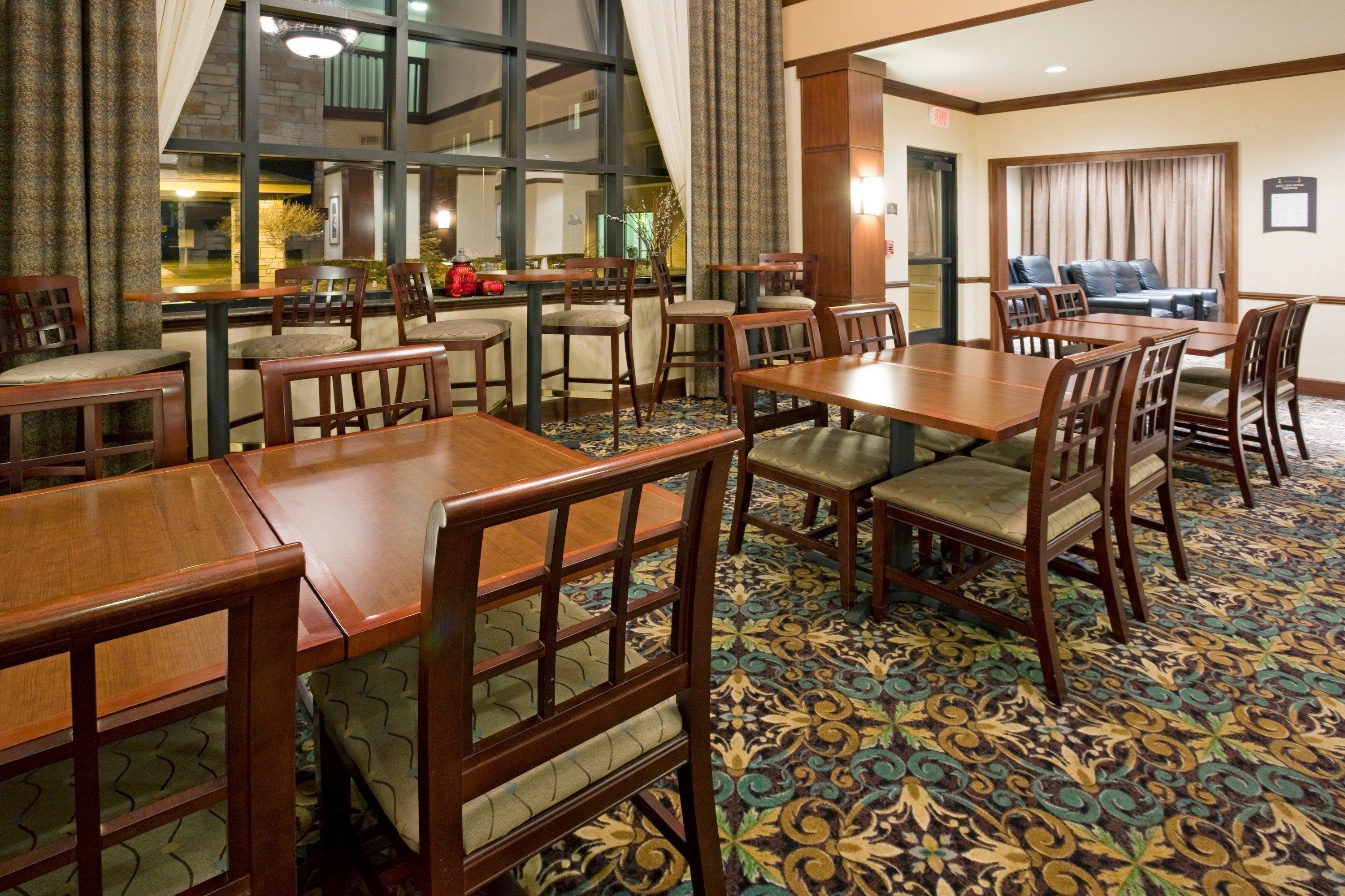 image Dining area featuring tables, chairs, and window views.