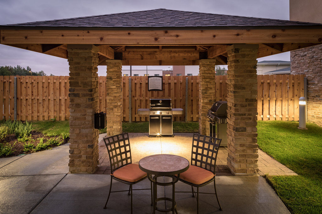 image Grill up your favorite meals in this charming, sheltered outdoor space, perfect for evening gatherings.